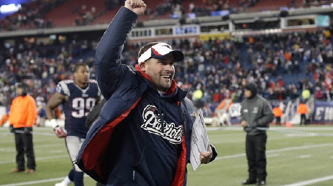 Dec 8, 2013; Foxborough, MA, USA; New England Patriots offensive coordinator Josh McDaniels raises his hand while leaving the field after their 27-26 win over the Cleveland Browns at Gillette Stadium. Mandatory Credit: Winslow Townson-Imagn Images
