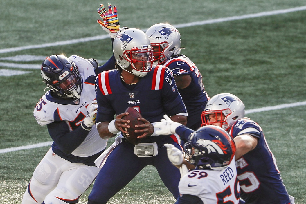 Oct 18, 2020; Foxborough, Massachusetts, USA; New England Patriots quarterback Cam Newton (1) drops back to pass under pressure from Denver Broncos linebacker Bradley Chubb (55) and linebacker Malik Reed (59) during the second half at Gillette Stadium.