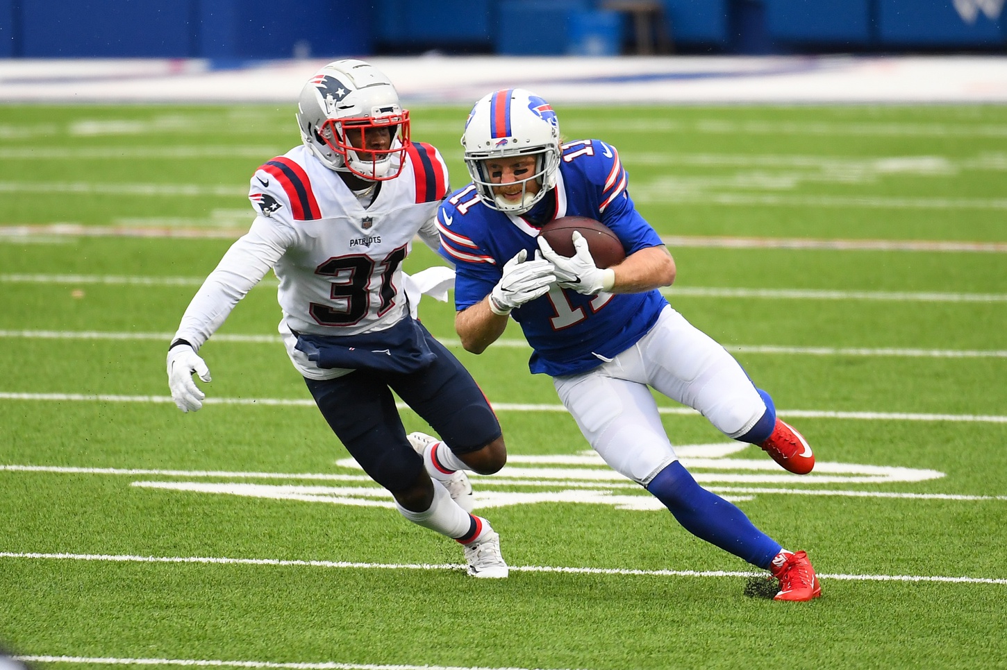 Nov 1, 2020; Orchard Park, New York, USA; Buffalo Bills wide receiver Cole Beasley (11) runs with the ball after a catch as New England Patriots defensive back Jonathan Jones (31) defends during the first quarter at Bills Stadium. Mandatory Credit: Rich Barnes-USA TODAY Sports