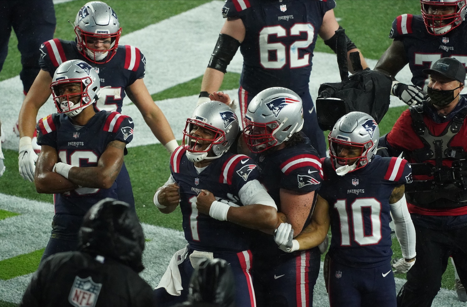 Nov 15, 2020; Foxborough, Massachusetts, USA; New England Patriots quarterback Cam Newton (1) and his teammates react to the on field TV monitor after scoring against the Baltimore Ravens during the second half at Gillette Stadium. Mandatory Credit: David Butler II-USA TODAY Sports