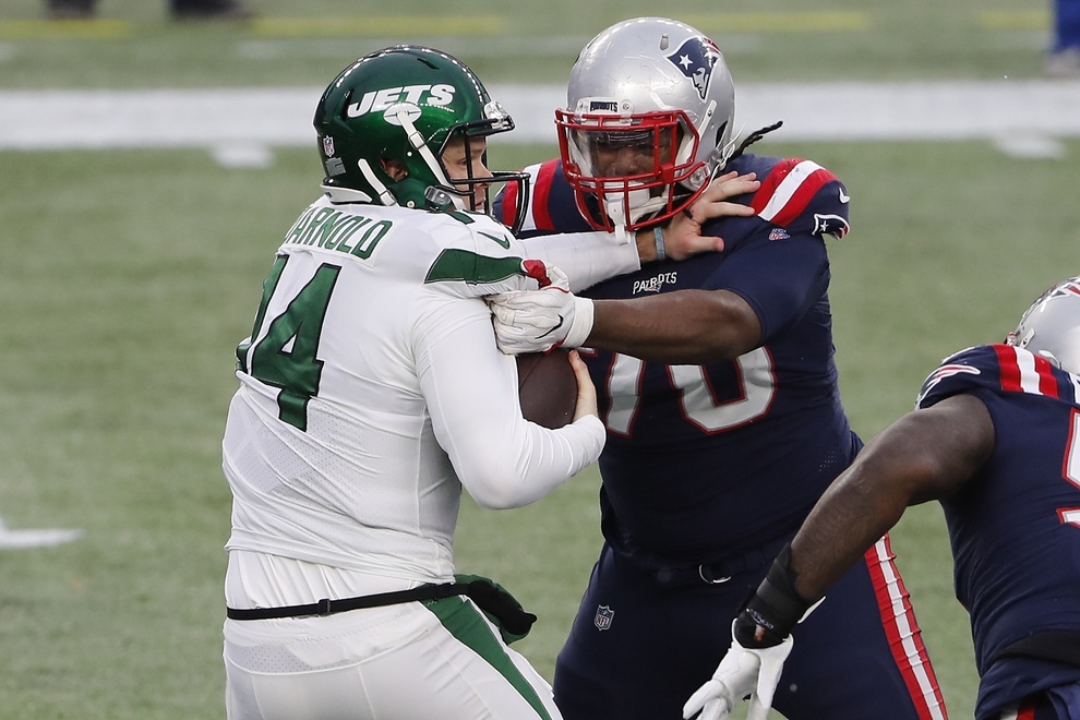 Jan 3, 2021; Foxborough, Massachusetts, USA; New York Jets quarterback Sam Darnold (14) is sacked by New England Patriots defensive tackle Adam Butler (70) during the second half at Gillette Stadium. Mandatory Credit: Winslow Townson-USA TODAY Sports