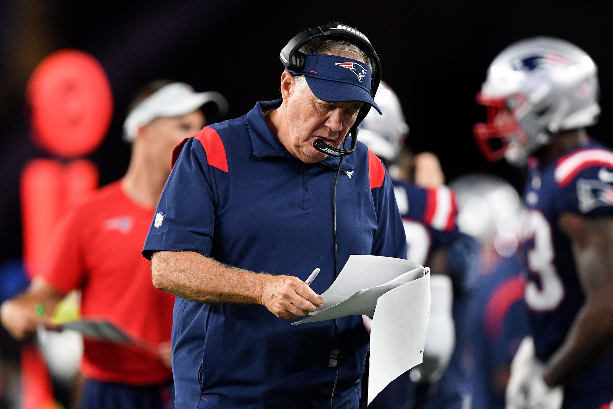Aug 12, 2021; Foxborough, Massachusetts, USA; New England Patriots head coach Bill Belichick looks at his notes during the second half of a game against the Washington Football Team at Gillette Stadium. Mandatory Credit: Brian Fluharty-USA TODAY Sports