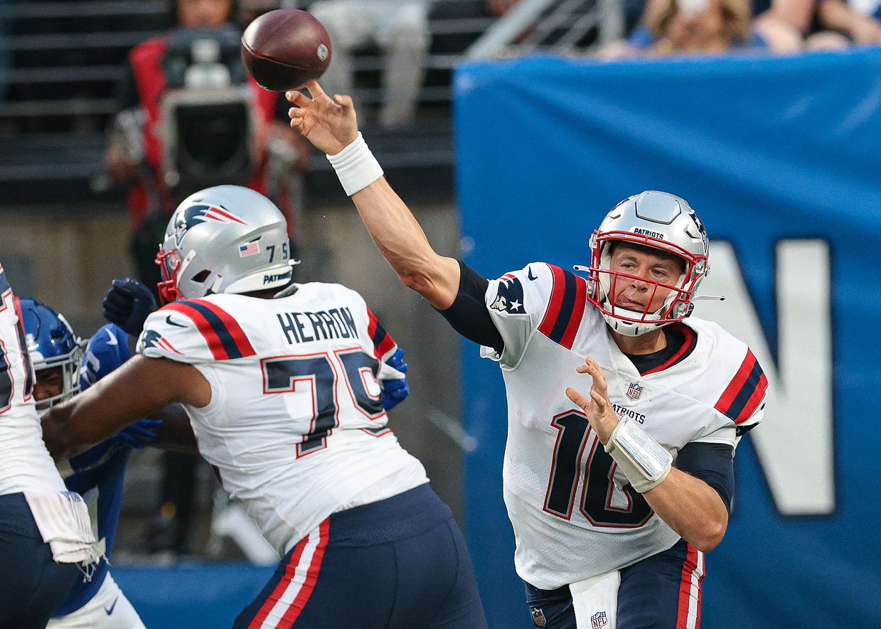 Aug 29, 2021; East Rutherford, New Jersey, USA; New England Patriots quarterback Mac Jones (10) throws the ball as offensive guard Justin Herron (75) blocks against the New York Giants during the first half at MetLife Stadium. Mandatory Credit: Vincent Carchietta-USA TODAY Sports