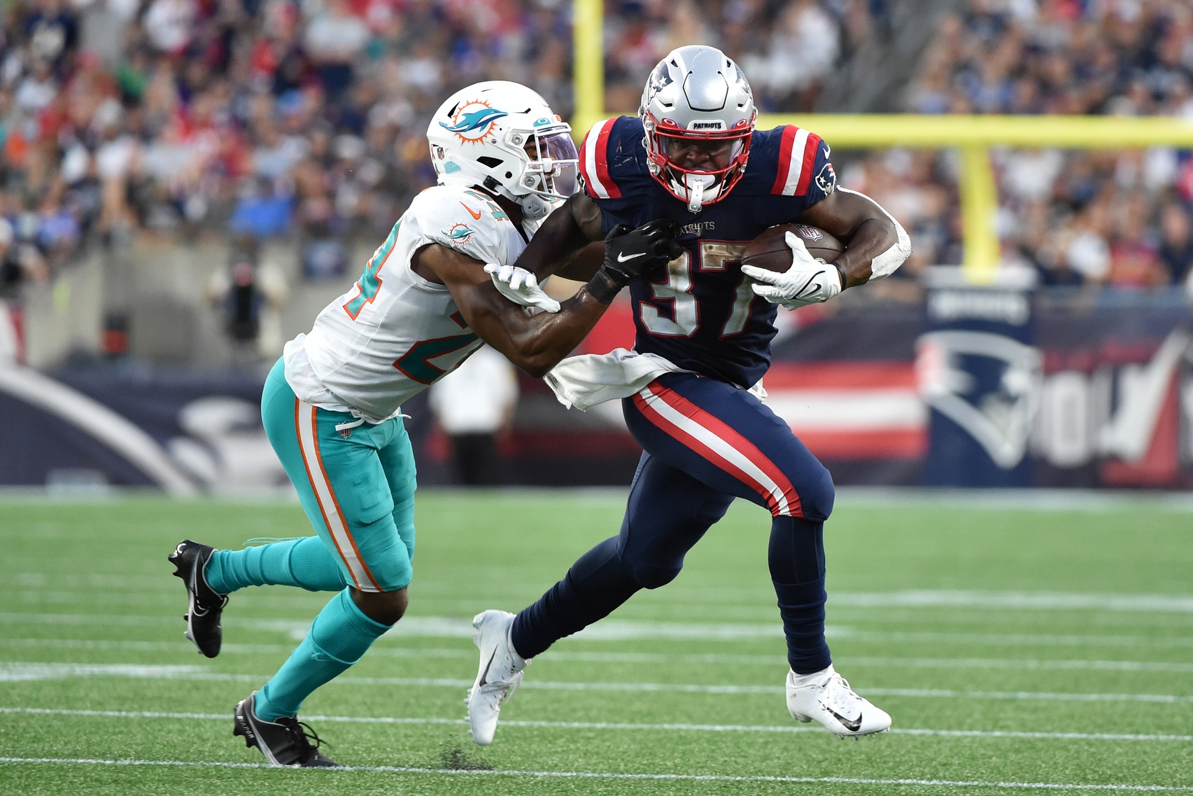 Sep 12, 2021; Foxborough, Massachusetts, USA;  New England Patriots running back Damien Harris (37) runs with the ball while getting tackled by Miami Dolphins cornerback Byron Jones (24) during the second half at Gillette Stadium. Mandatory Credit: Bob DeChiara-USA TODAY Sports