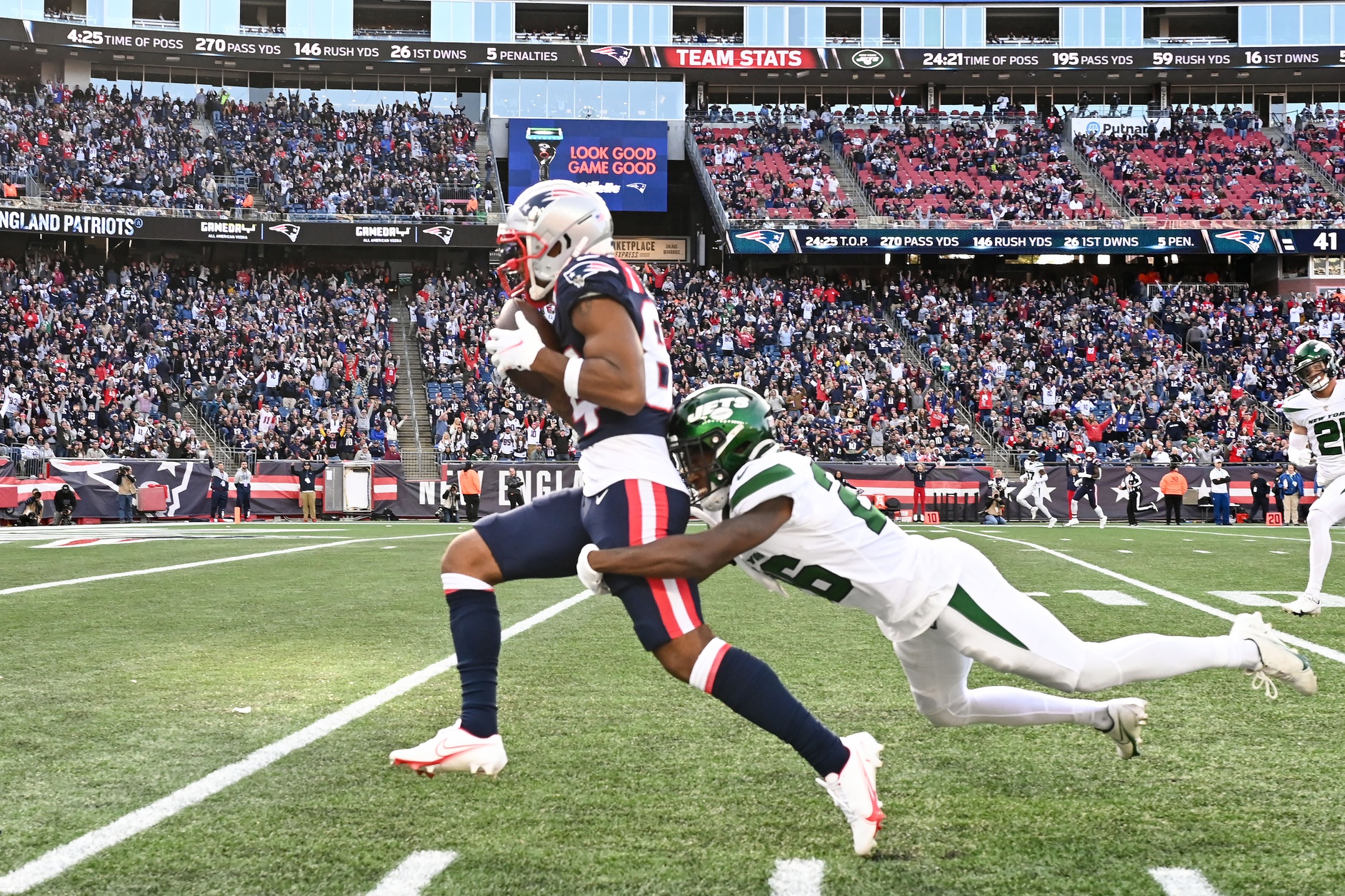Oct 24, 2021; Foxborough, Massachusetts, USA; New York Jets cornerback Brandin Echols (26) tackles New England Patriots wide receiver Kendrick Bourne (84) during the second half at Gillette Stadium. Mandatory Credit: Brian Fluharty-USA TODAY Sports