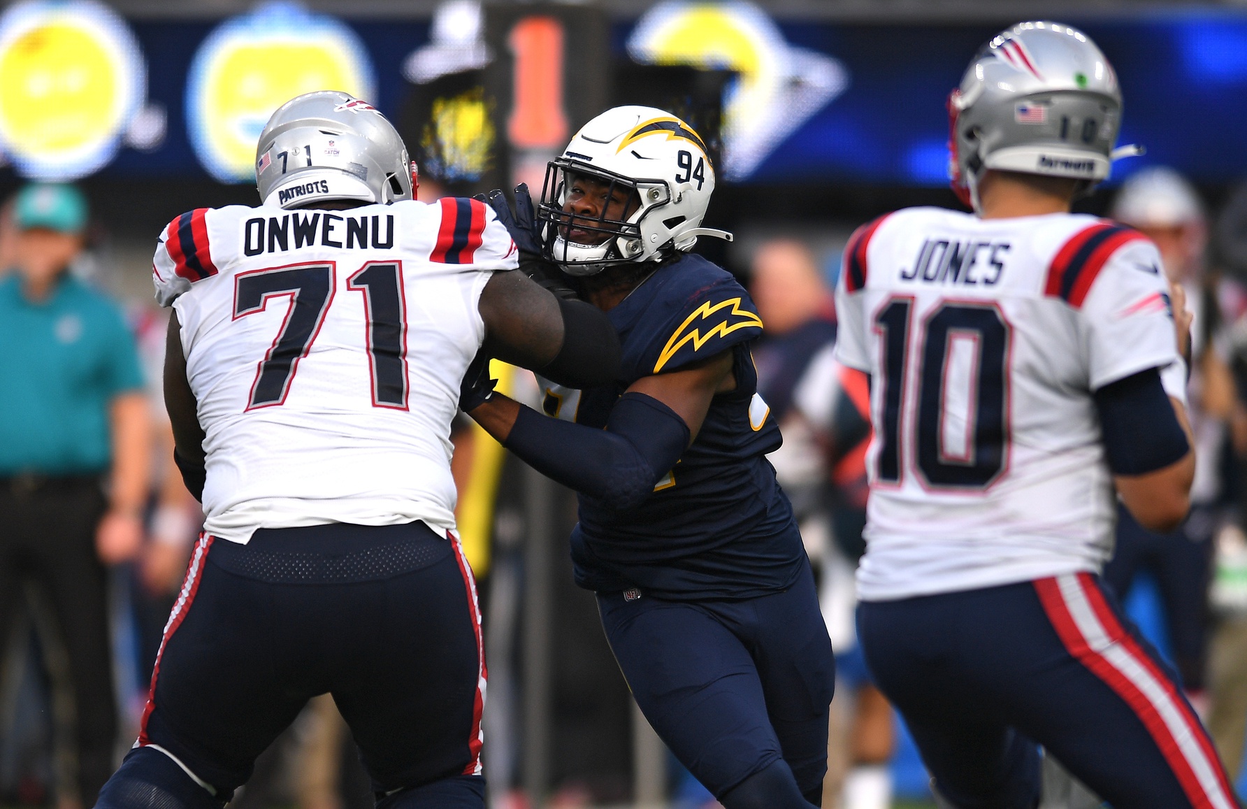 Oct 31, 2021; Inglewood, California, USA; New England Patriots guard Mike Onwenu (71) blocks Los Angeles Chargers linebacker Chris Rumph II (94) during the second half at SoFi Stadium. Mandatory Credit: Orlando Ramirez-USA TODAY Sports