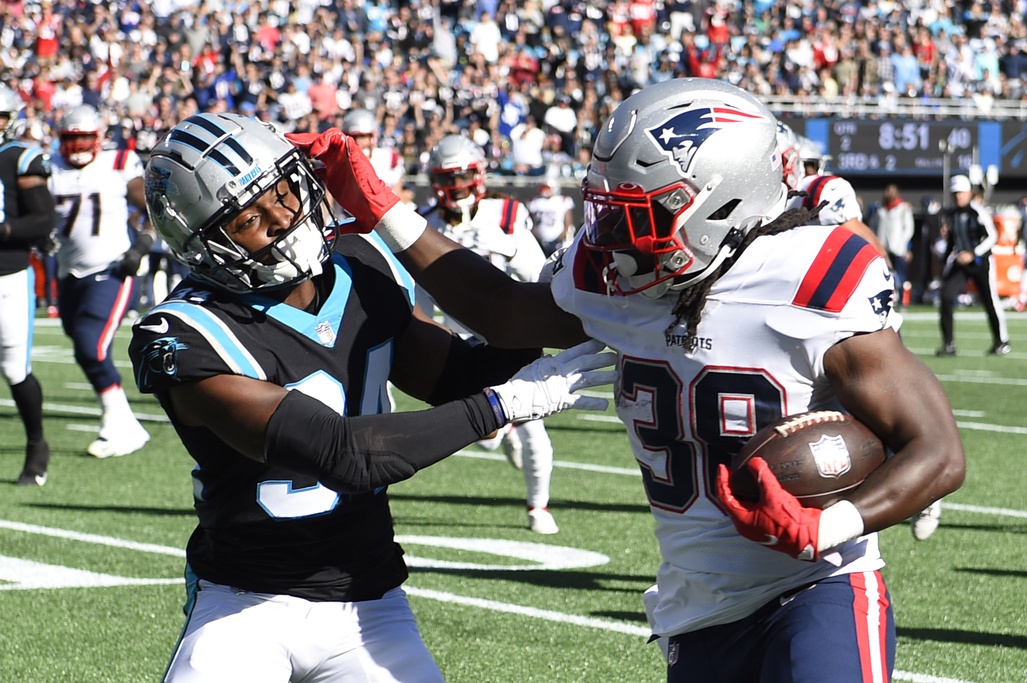 Nov 7, 2021; Charlotte, North Carolina, USA;  New England Patriots running back Rhamondre Stevenson (38) runs as Carolina Panthers safety Sean Chandler (34) defends in the first quarter at Bank of America Stadium. Mandatory Credit: Bob Donnan-USA TODAY Sports