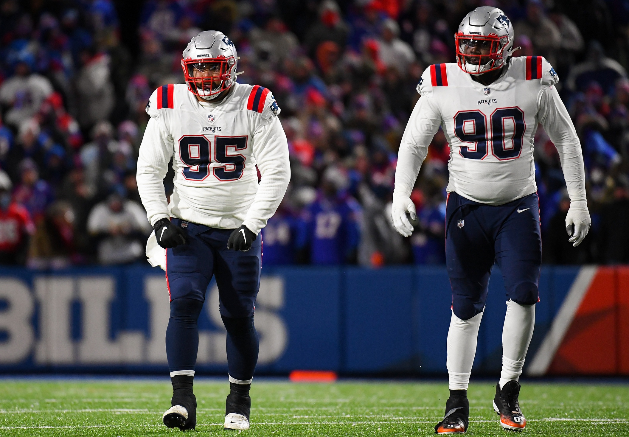 Dec 6, 2021; Orchard Park, New York, USA; New England Patriots defensive tackle Daniel Ekuale (95) and defensive end Christian Barmore (90) reacts to a play against the Buffalo Bills during the first half at Highmark Stadium. Mandatory Credit: Rich Barnes-USA TODAY Sports