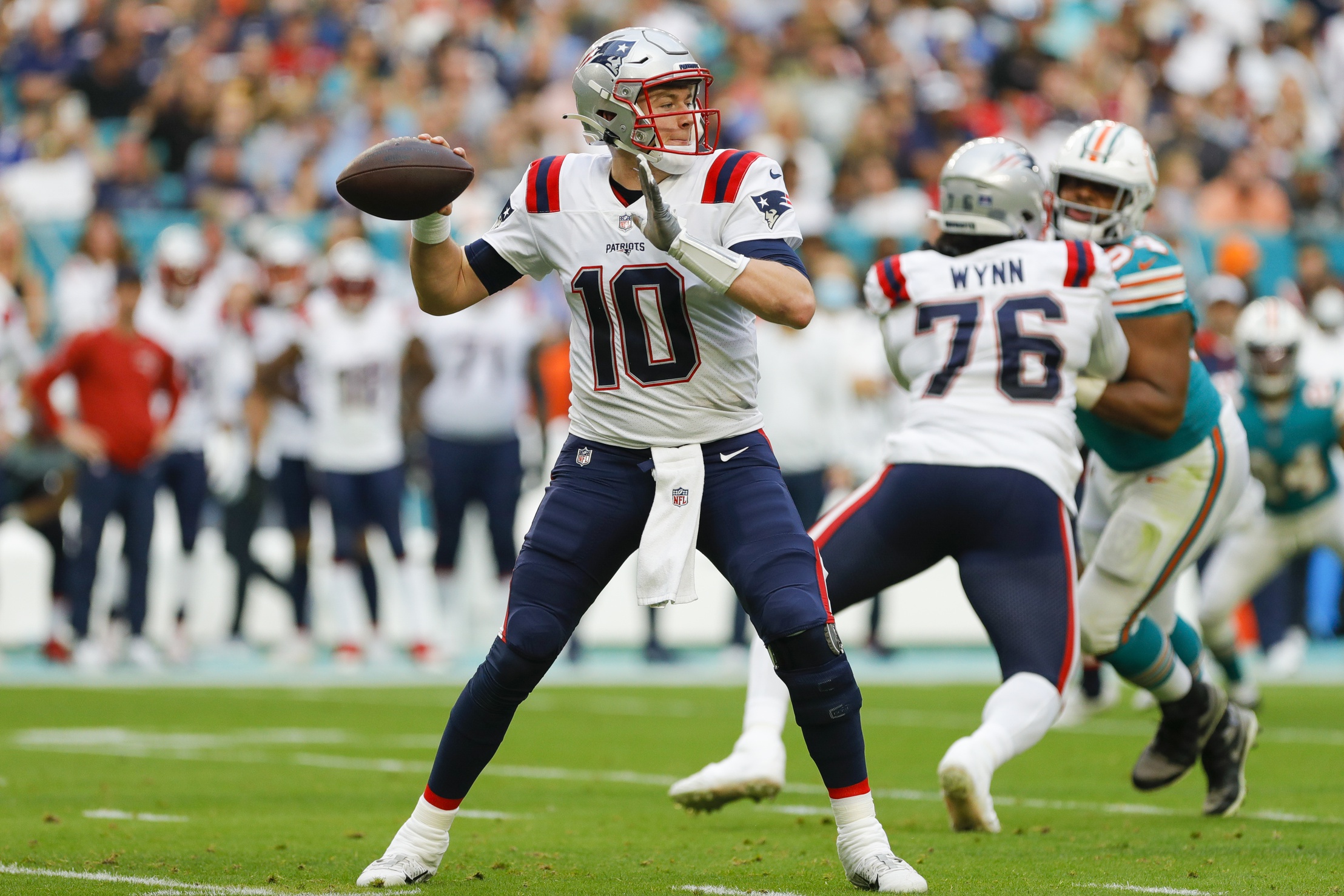 Jan 9, 2022; Miami Gardens, Florida, USA; New England Patriots quarterback Mac Jones (10) attempts to throw the football against the Miami Dolphins during the first quarter at Hard Rock Stadium. Mandatory Credit: Sam Navarro-USA TODAY Sports