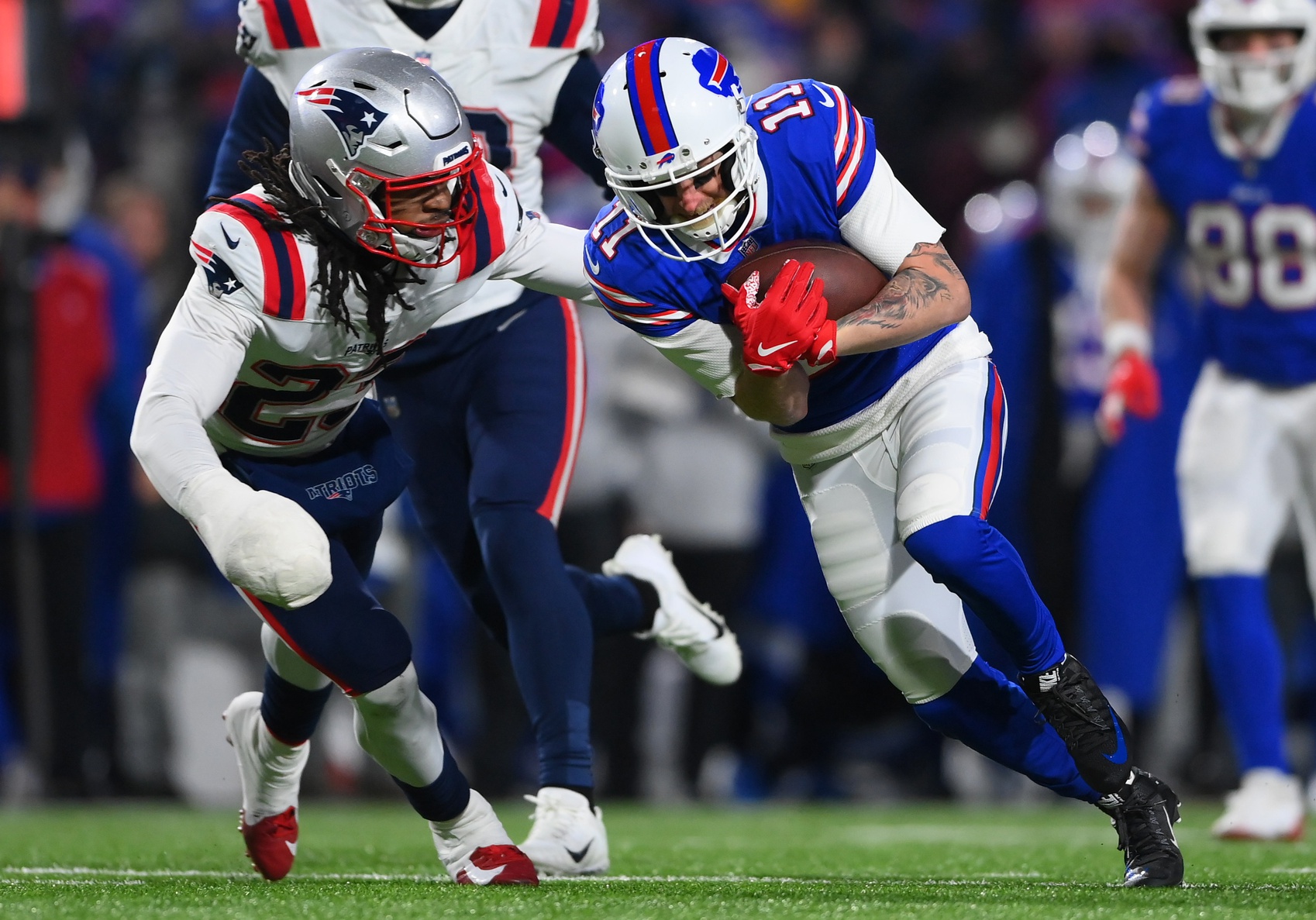 Jan 15, 2022; Orchard Park, New York, USA; Buffalo Bills wide receiver Cole Beasley (11) runs against New England Patriots safety Kyle Dugger (23) during the third quarter of the AFC Wild Card playoff game at Highmark Stadium. Mandatory Credit: Rich Barnes-USA TODAY Sports