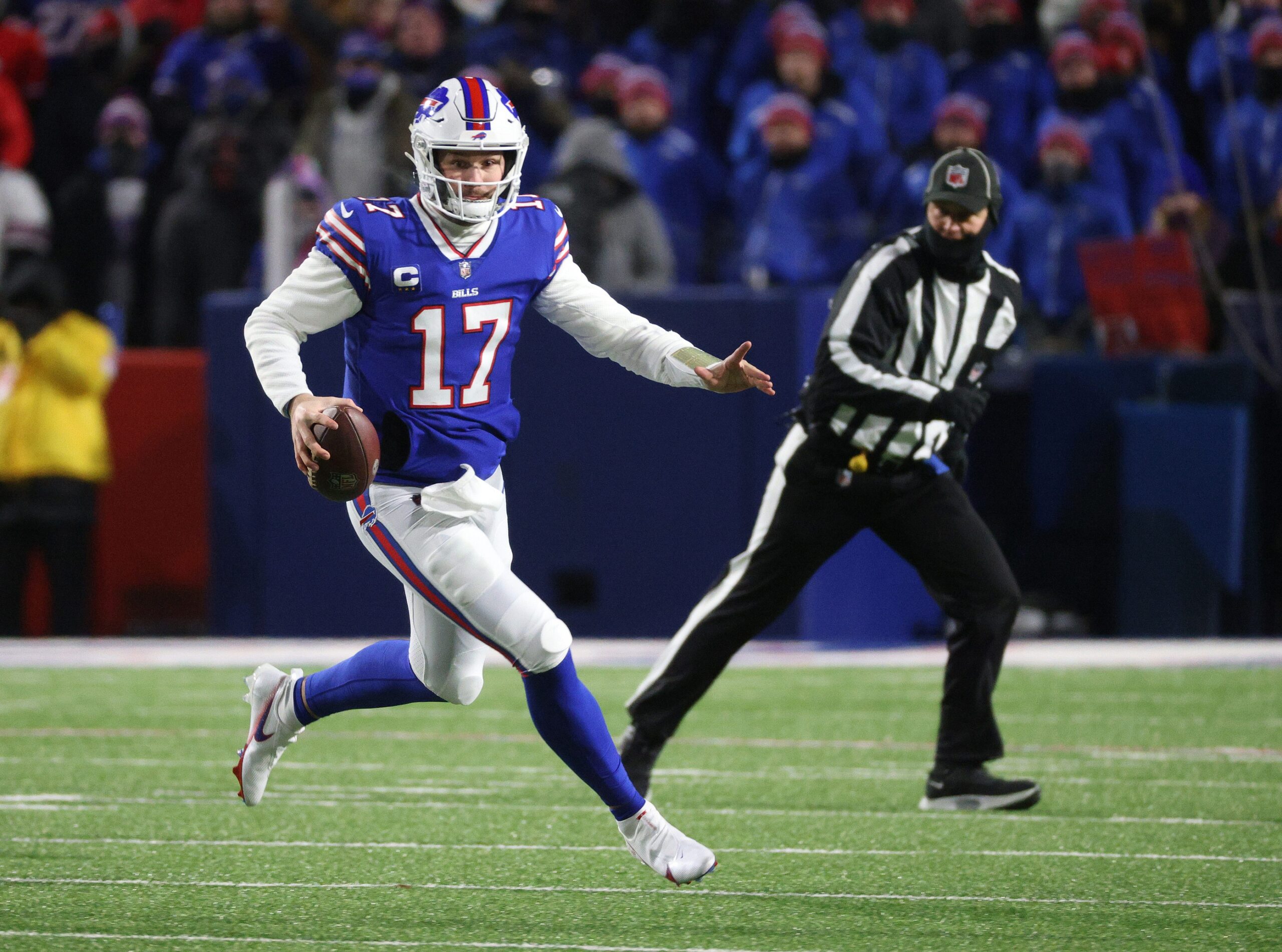 Bills quarterback Josh Allen rolls to his left against the Patriots.
