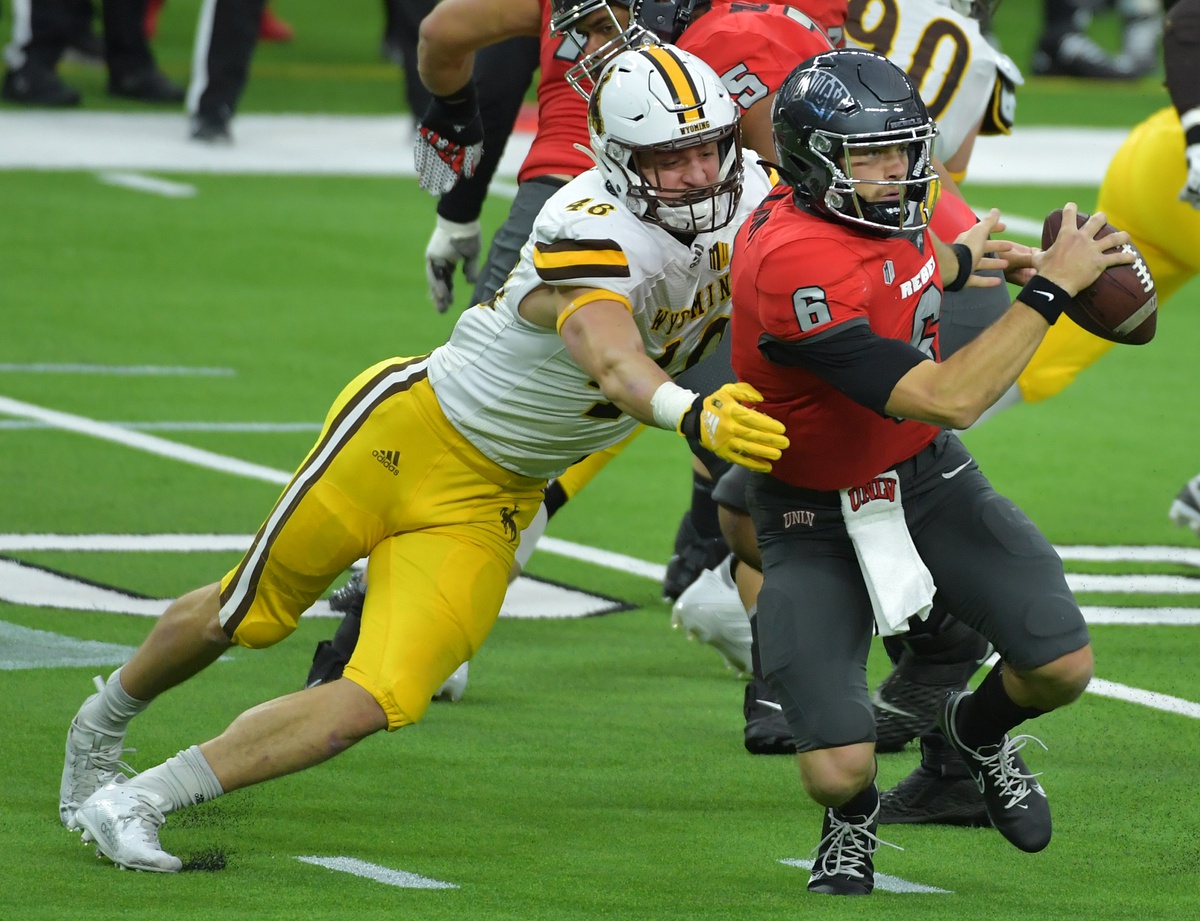 Nov 27, 2020; Paradise, Nevada, USA; Wyoming Cowboys linebacker Chad Muma (48) sacks UNLV Rebels quarterback Max Gilliam (6) during the second quarter at Allegiant Stadium. Mandatory Credit: Stephen R. Sylvanie-USA TODAY Sports