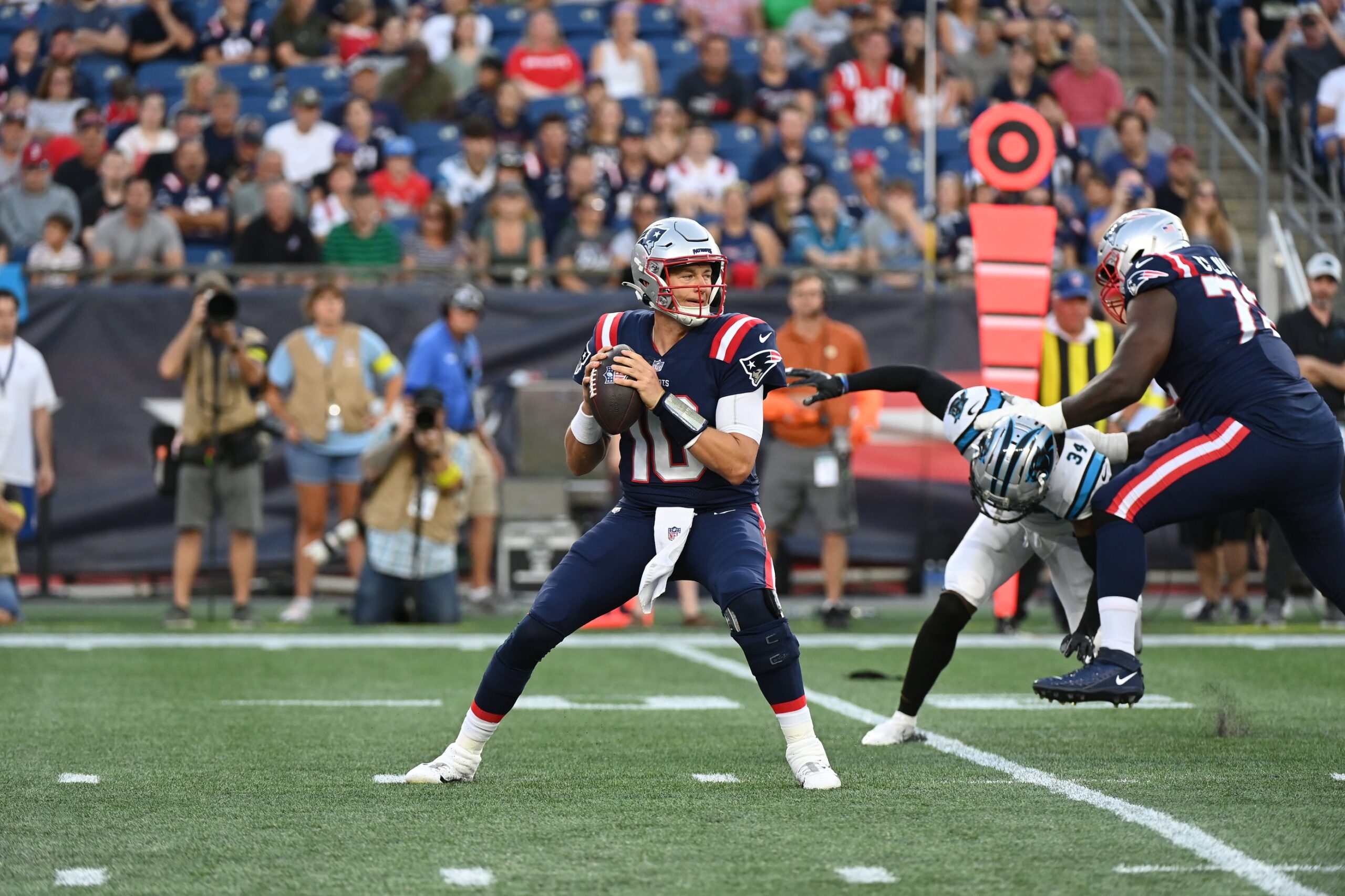 Aug 19, 2022; Foxborough, Massachusetts, USA; New England Patriots quarterback Mac Jones (10) drops back to pass during the first half of a preseason game against the Carolina Panthersat Gillette Stadium. Mandatory Credit: Eric Canha-USA TODAY Sports