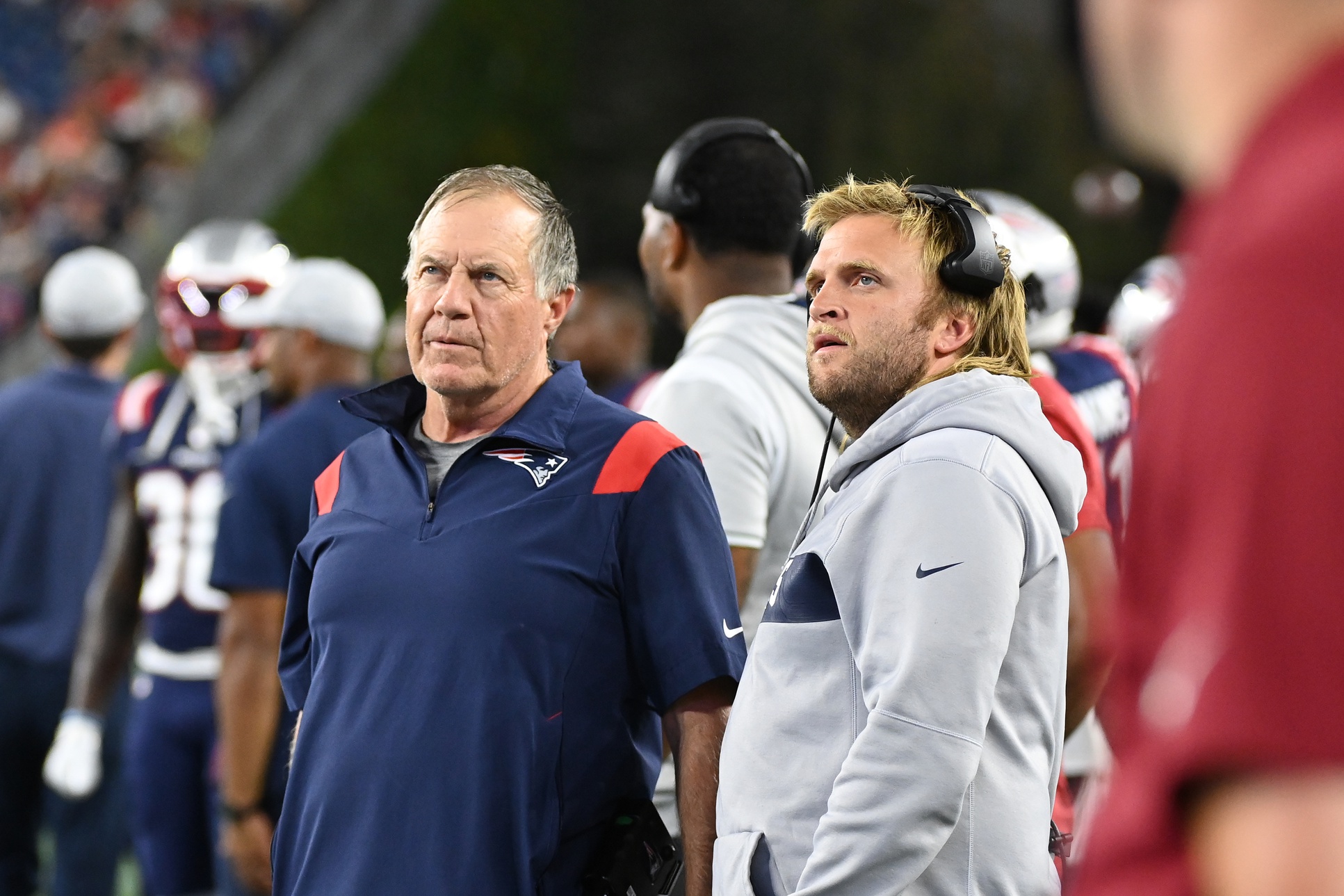 Aug 19, 2022; Foxborough, Massachusetts, USA;  New England Patriots head coach Bill Belichick (left) and Steve Belichick, linebackers coach (right) watch the in stadium displays during the first half of a preseason against the Carolina Panthers game at Gillette Stadium. Mandatory Credit: Eric Canha-USA TODAY Sports