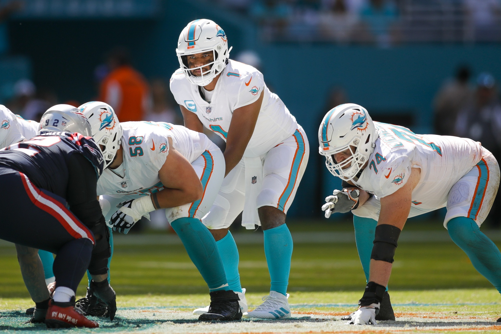 Sep 11, 2022; Miami Gardens, Florida, USA; Miami Dolphins quarterback Tua Tagovailoa (1) watches from the line of scrimmage prior to the snap during the fourth quarter against the New England Patriots at Hard Rock Stadium. Mandatory Credit: Sam Navarro-USA TODAY Sports