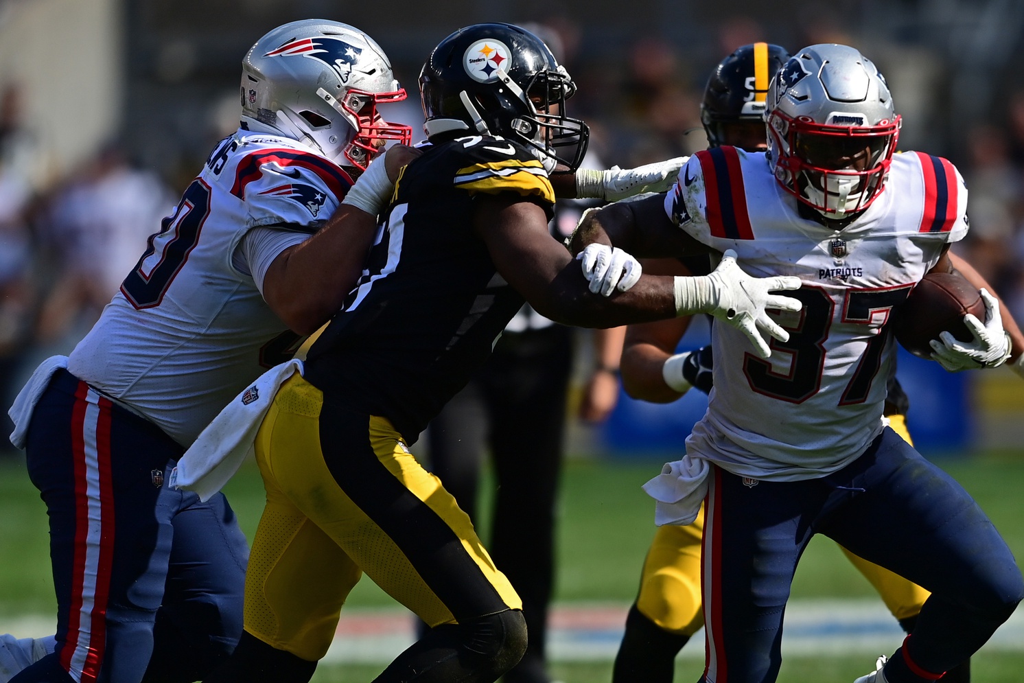 Sep 18, 2022; Pittsburgh, Pennsylvania, USA; New England Patriots running back Damien Harris (37) runs through Pittsburgh Steelers linebacker Myles Jack (51) during the fourth quarter at Acrisure Stadium. Mandatory Credit: David Dermer-USA TODAY Sports