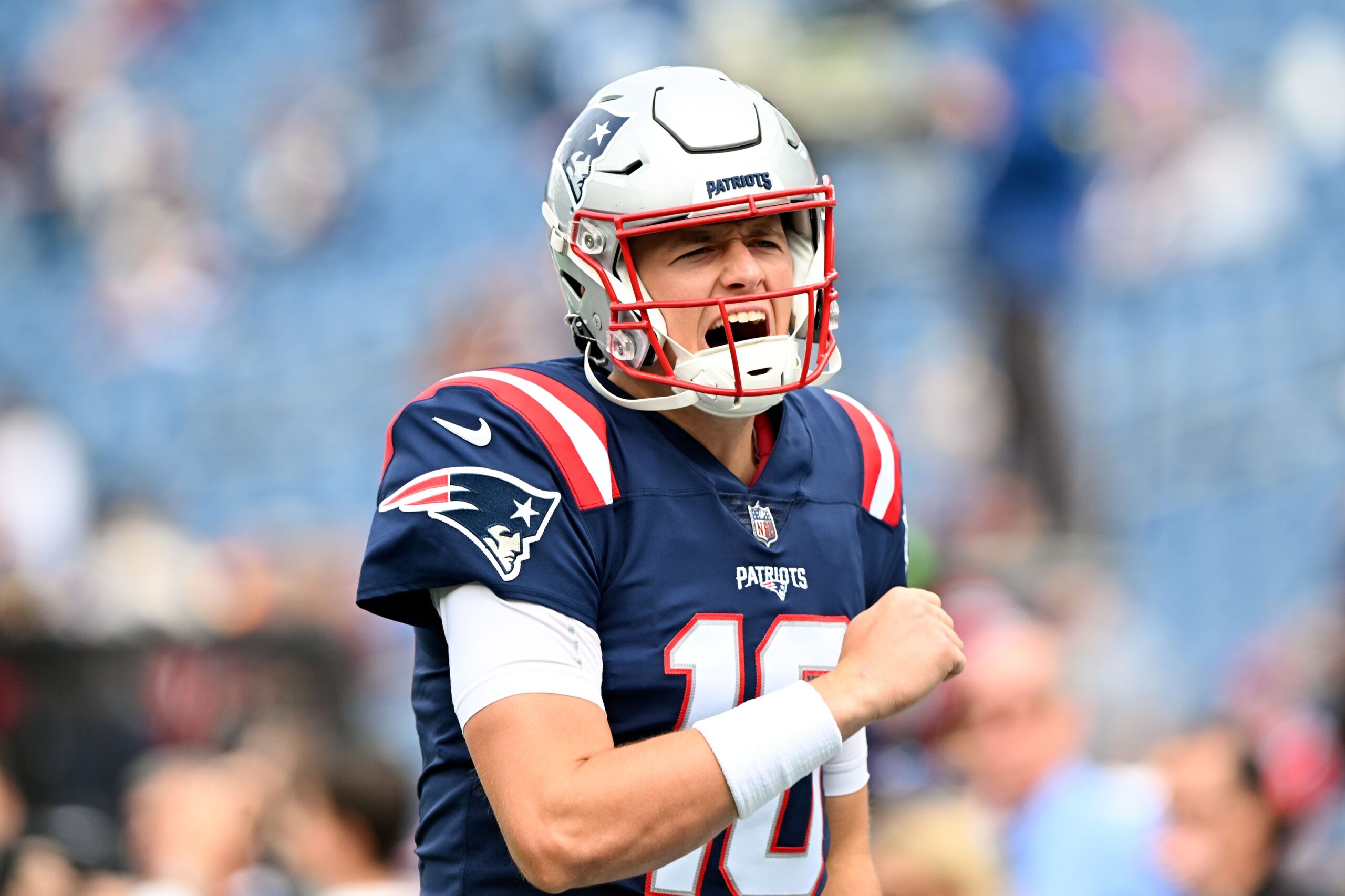 Sep 25, 2022; Foxborough, Massachusetts, USA; New England Patriots quarterback Mac Jones (10) reacts after running onto the field before a game against the Baltimore Ravens at Gillette Stadium. Mandatory Credit: Brian Fluharty-USA TODAY Sports