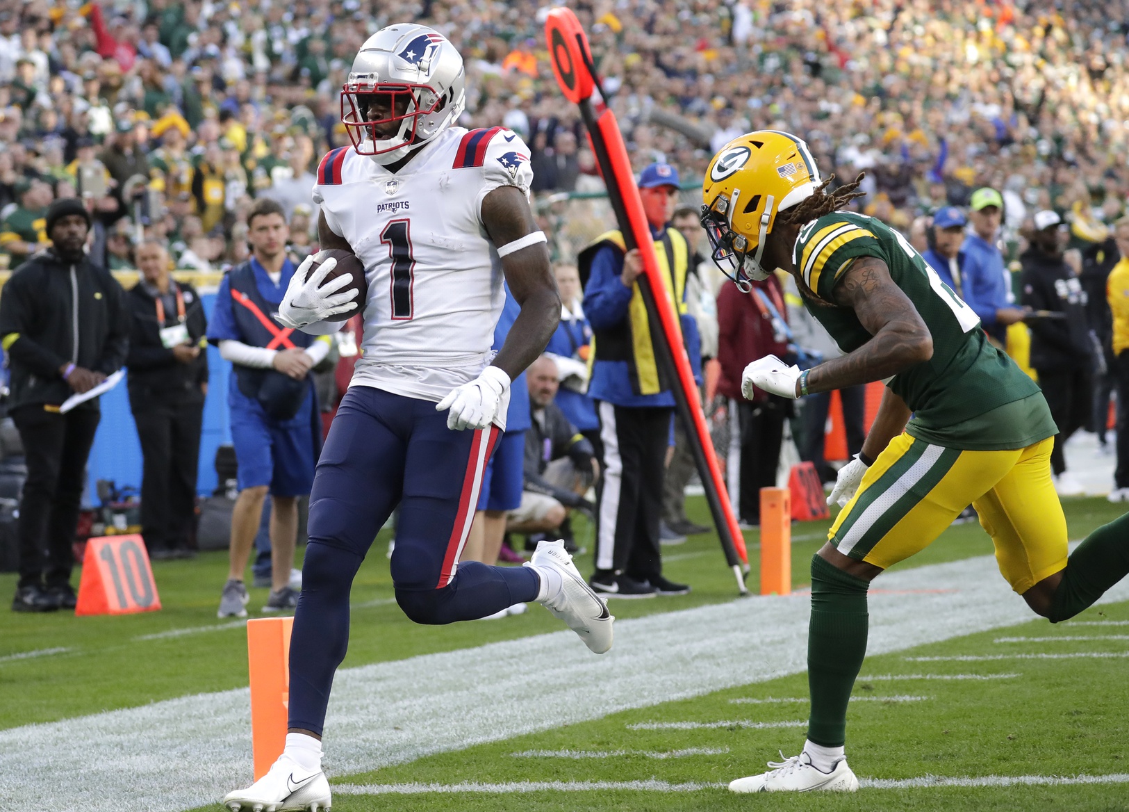 Oct 2, 2022; Green Bay, Wisconsin, USA; New England Patriots wide receiver DeVante Parker (1) scores a touchdown against Green Bay Packers cornerback Eric Stokes (21) during the second half at Lambeau Field. Mandatory Credit: Dan Powers/Appleton Post-Crescent-USA TODAY NETWORK-Wisconsin
