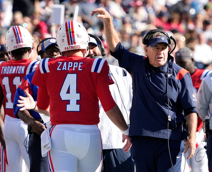 Patriots QB #4 Bailey Zappe gets a tap on the helmet from head coach Bill Belichick after he ran the ball in the 4th to set up a Patriot field goal.

17 Patslions 100922 Bb