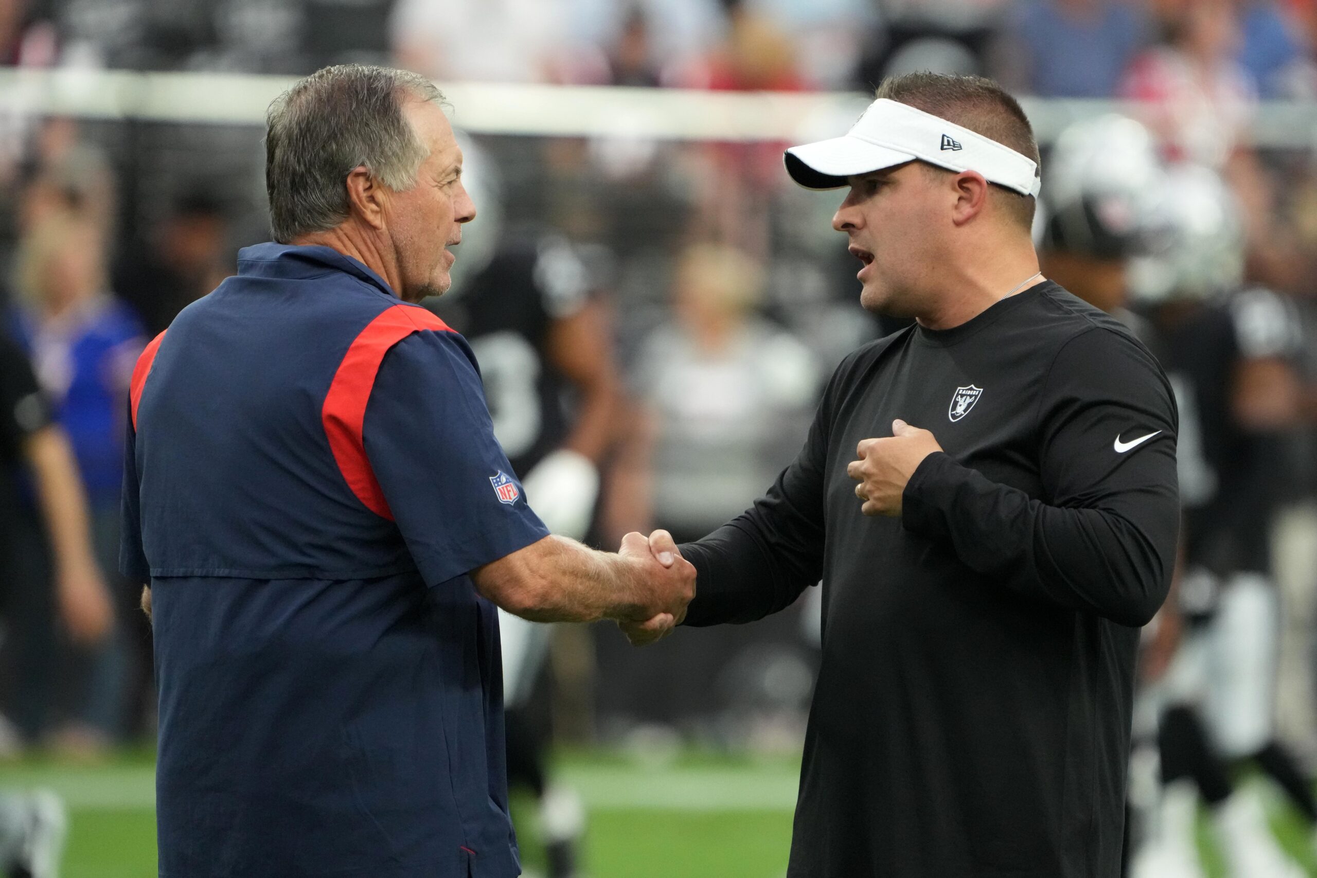 Aug 26, 2022; Paradise, Nevada, USA; New England Patriots head coach Bill Belichick (left) shakes hands with Las Vegas Raiders coach Josh McDaniels before the game at Allegiant Stadium. Mandatory Credit: Kirby Lee-USA TODAY Sports