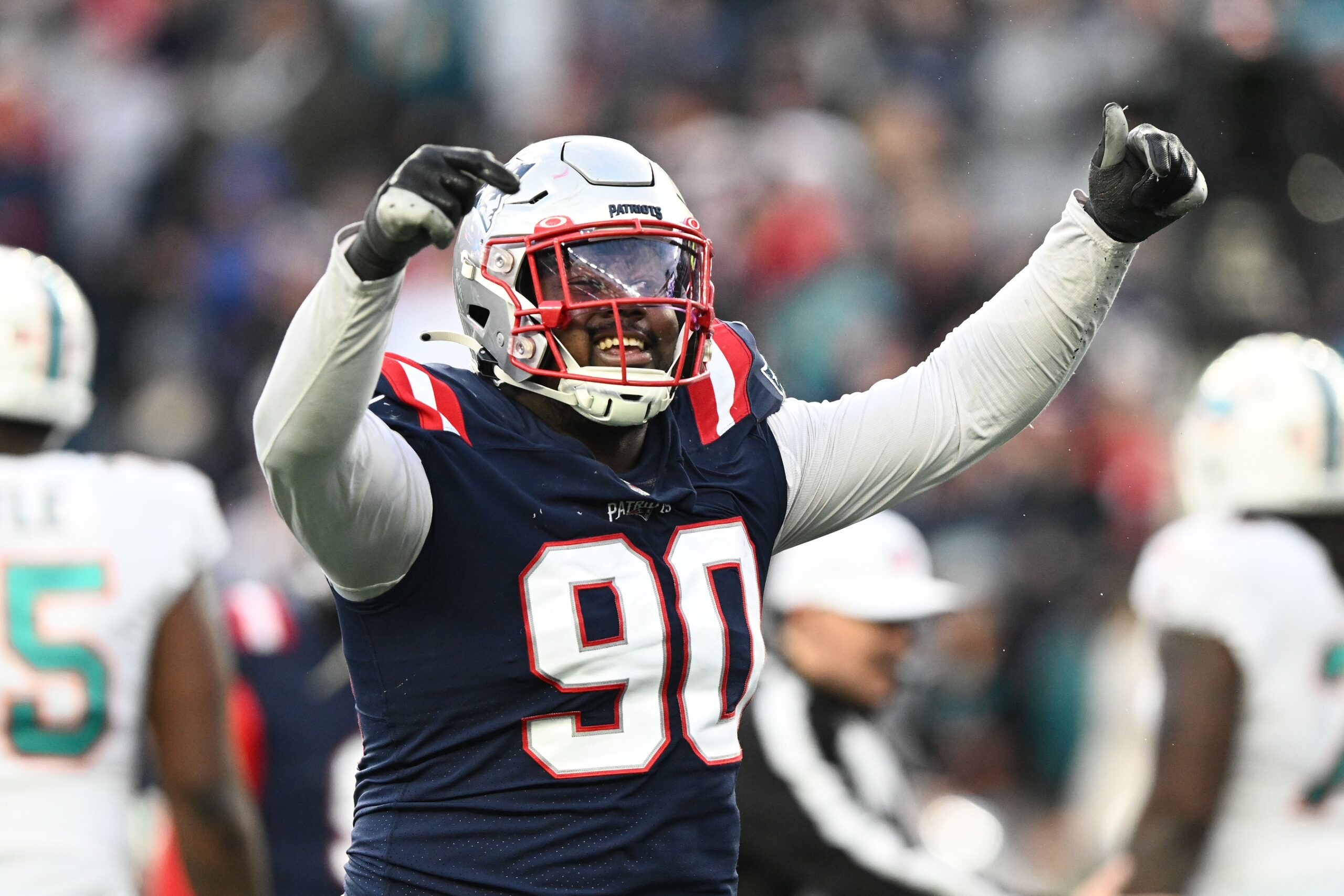 Jan 1, 2023; Foxborough, Massachusetts, USA; New England Patriots defensive tackle Christian Barmore (90) reacts after a sack against the Miami Dolphins during the second half at Gillette Stadium. Mandatory Credit: Brian Fluharty-USA TODAY Sports