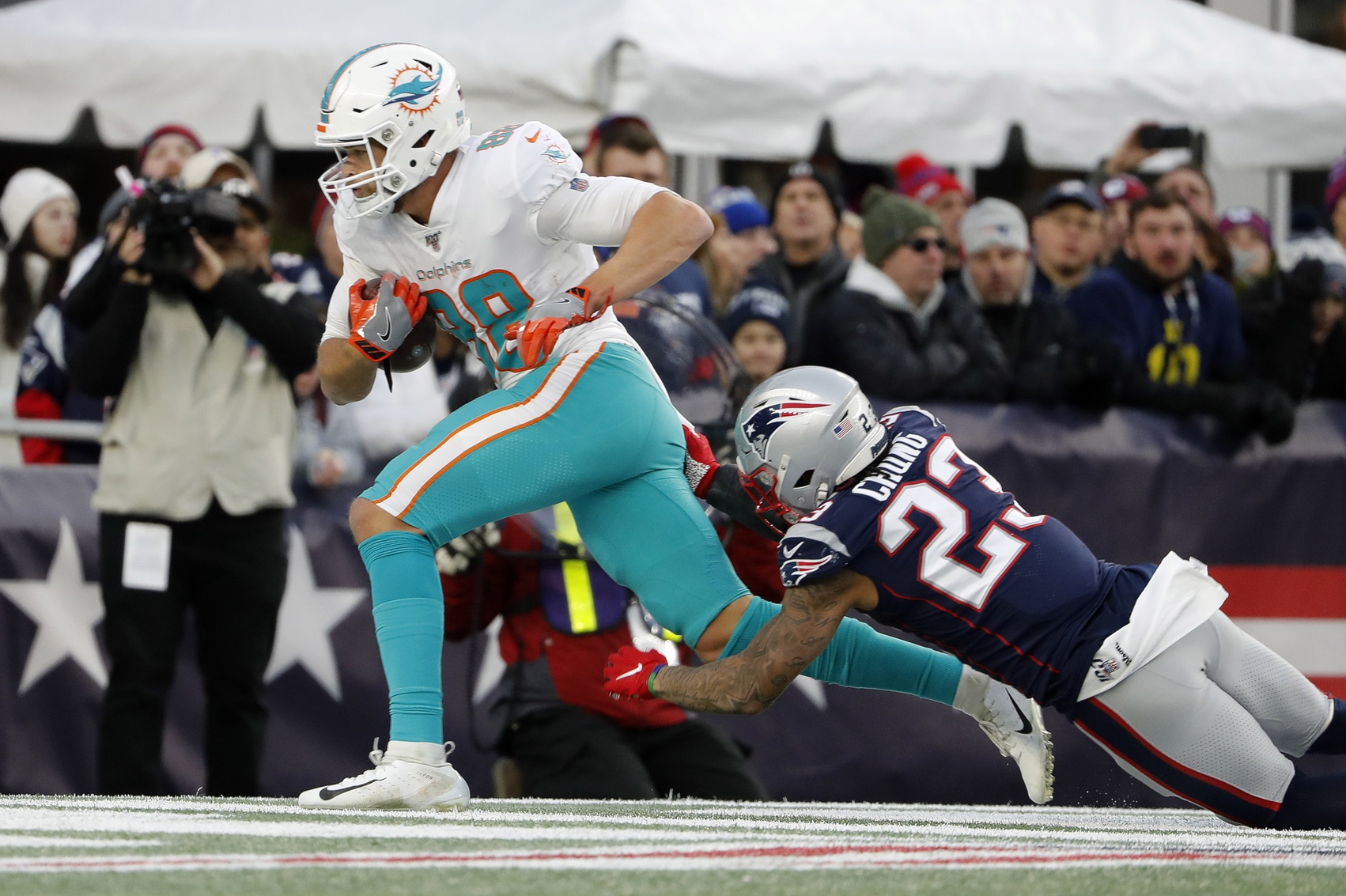 Dec 29, 2019; Foxborough, Massachusetts, USA; Miami Dolphins tight end Mike Gesicki (88) scores the winning touchdown behind New England Patriots strong safety Patrick Chung (23) with less than a minute to go in the fourth quarter at Gillette Stadium. Mandatory Credit: Winslow Townson-USA TODAY Sports