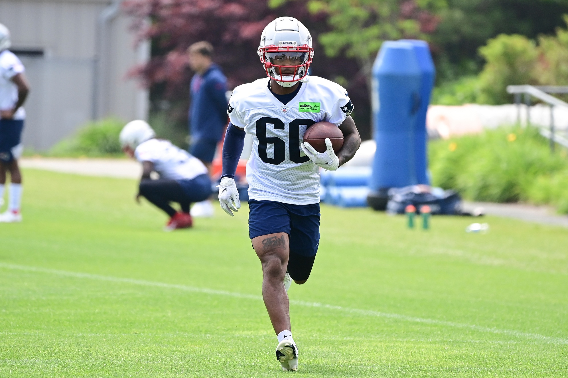 Jun 12, 2023; Foxborough, MA, USA; New England Patriots wide receiver Demario Douglas (60) runs after making a catch at the Patriots minicamp at Gillette Stadium.  Mandatory Credit: Eric Canha-USA TODAY Sports