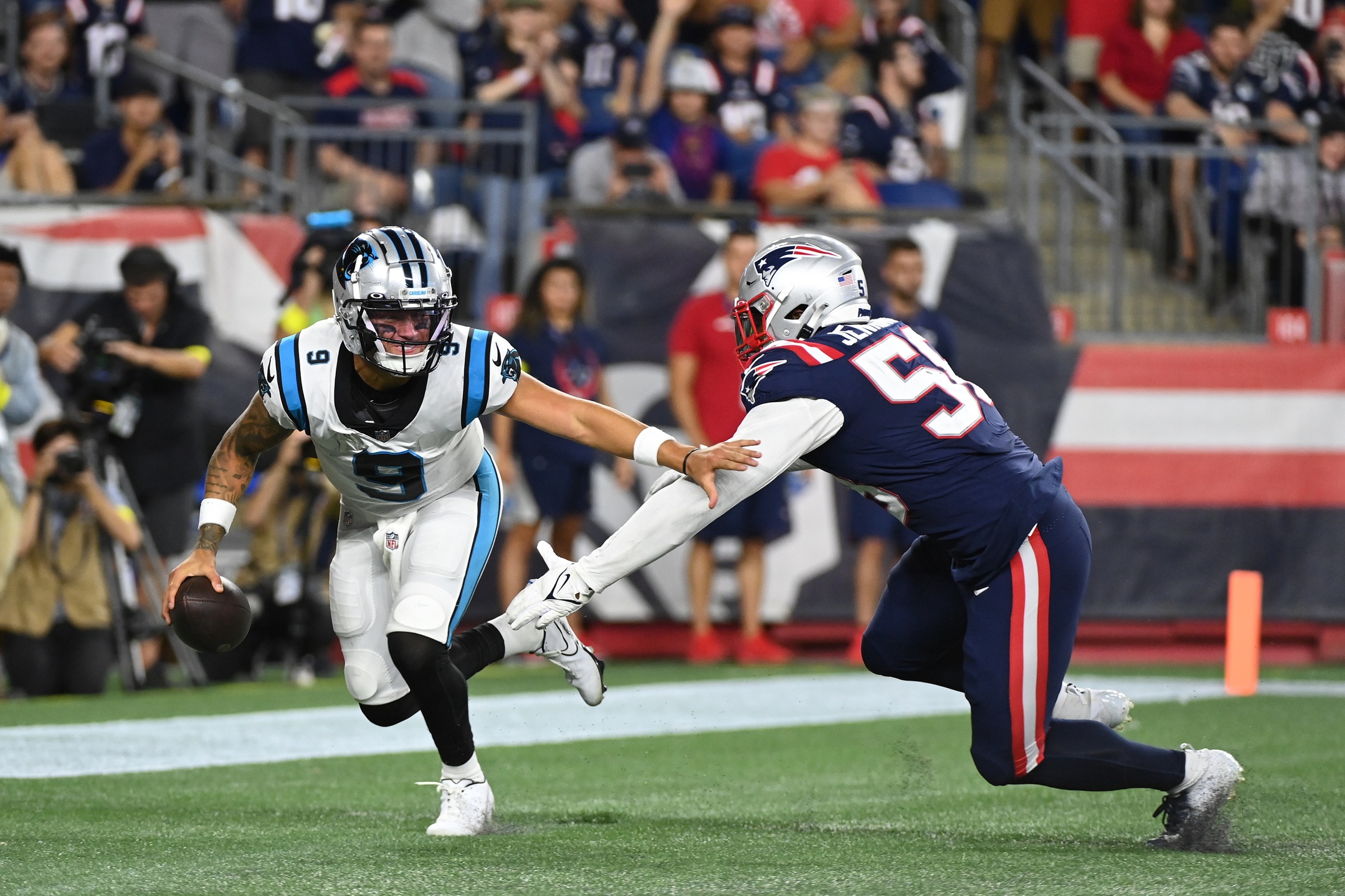 Aug 19, 2022; Foxborough, Massachusetts, USA; New England Patriots linebacker Anfernee Jennings (58) chases Carolina Panthers quarterback Matt Corral (9) in the end zone during the second half of a preseason game at Gillette Stadium. Mandatory Credit: Eric Canha-USA TODAY Sports