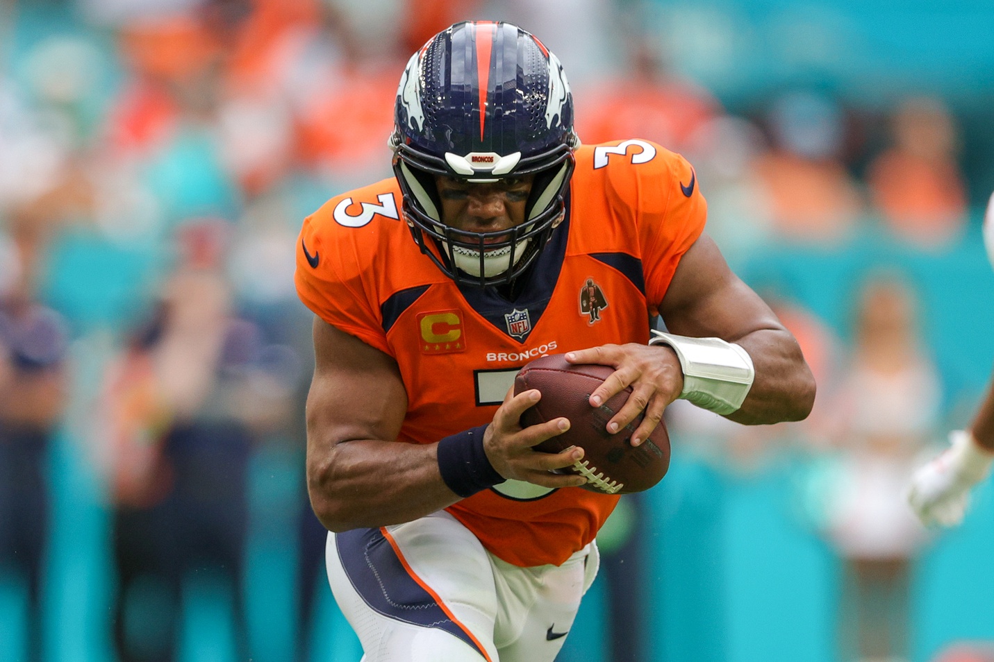 Sep 24, 2023; Miami Gardens, Florida, USA;  Denver Broncos quarterback Russell Wilson (3) runs with the ball against the Miami Dolphins in the fourth quarter at Hard Rock Stadium. Mandatory Credit: Nathan Ray Seebeck-USA TODAY Sports