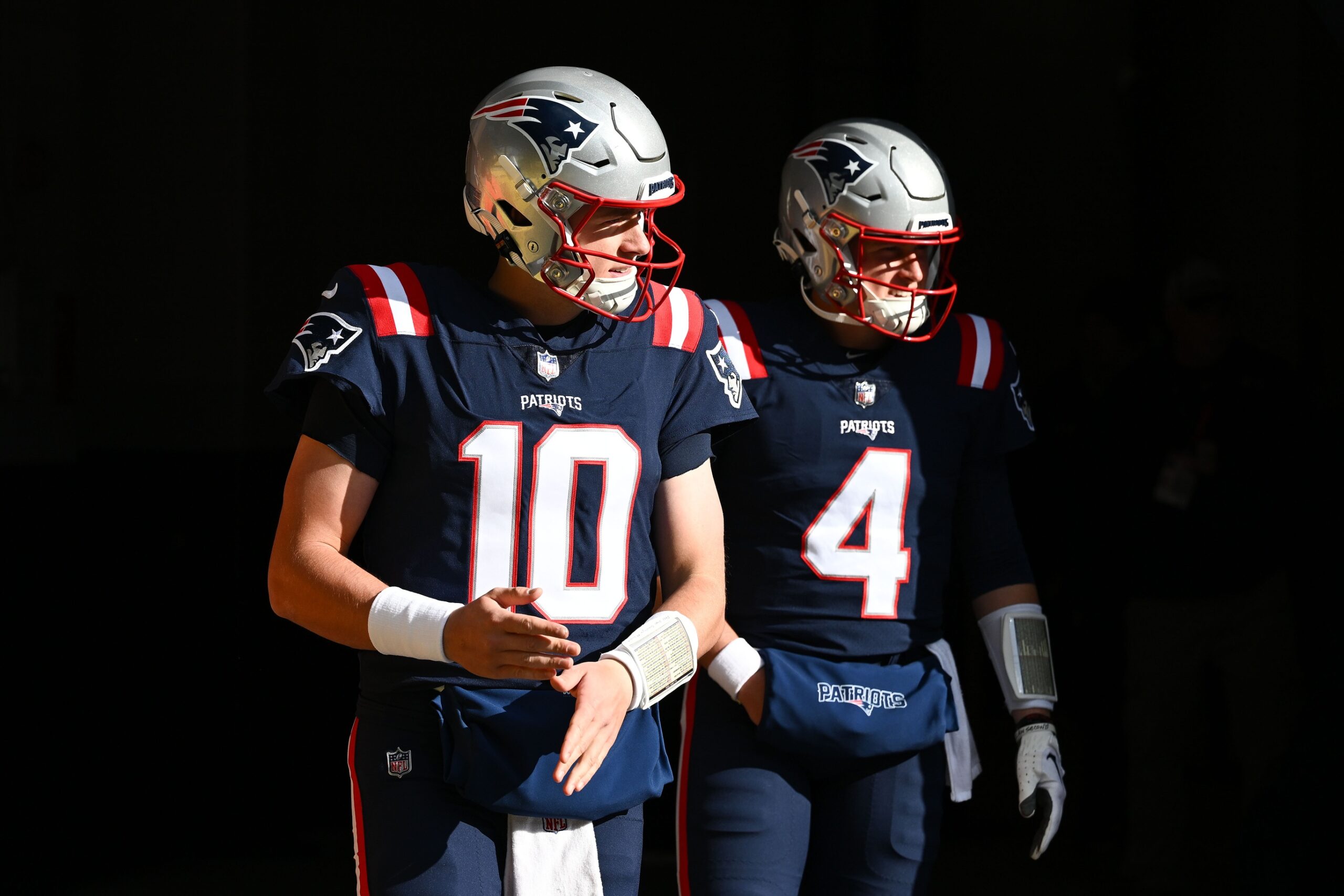 Nov 20, 2022; Foxborough, Massachusetts, USA; New England Patriots quarterback Mac Jones (10) and quarterback Bailey Zappe (4) walk onto the field before a game against the New York Jets at Gillette Stadium. Mandatory Credit: Brian Fluharty-USA TODAY Sports