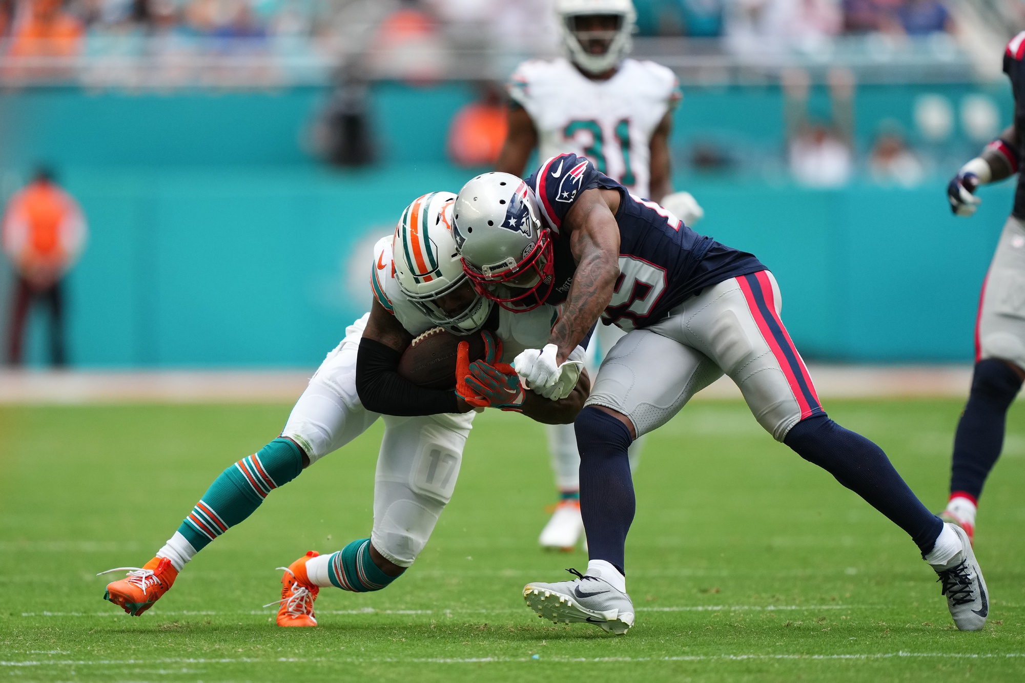 Oct 29, 2023; Miami Gardens, Florida, USA; New England Patriots cornerback J.C. Jackson (29) attempts to tackle Miami Dolphins wide receiver Jaylen Waddle (17) during the second half at Hard Rock Stadium. Mandatory Credit: Jasen Vinlove-USA TODAY Sports