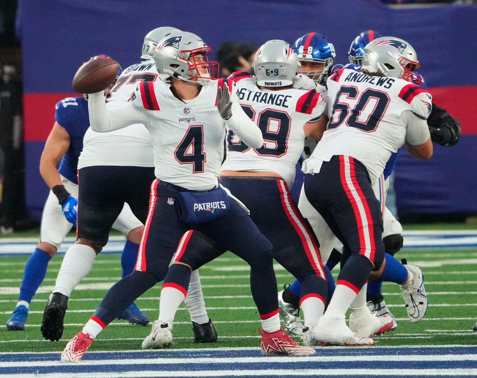 Nov 26, 2023; East Rutherford, New Jersey, USA; New England Patriots quarterback Bailey Zappe (4) throws against the New York Giants in the 4th quarter  at MetLife Stadium. Mandatory Credit: Robert Deutsch-USA TODAY Sports