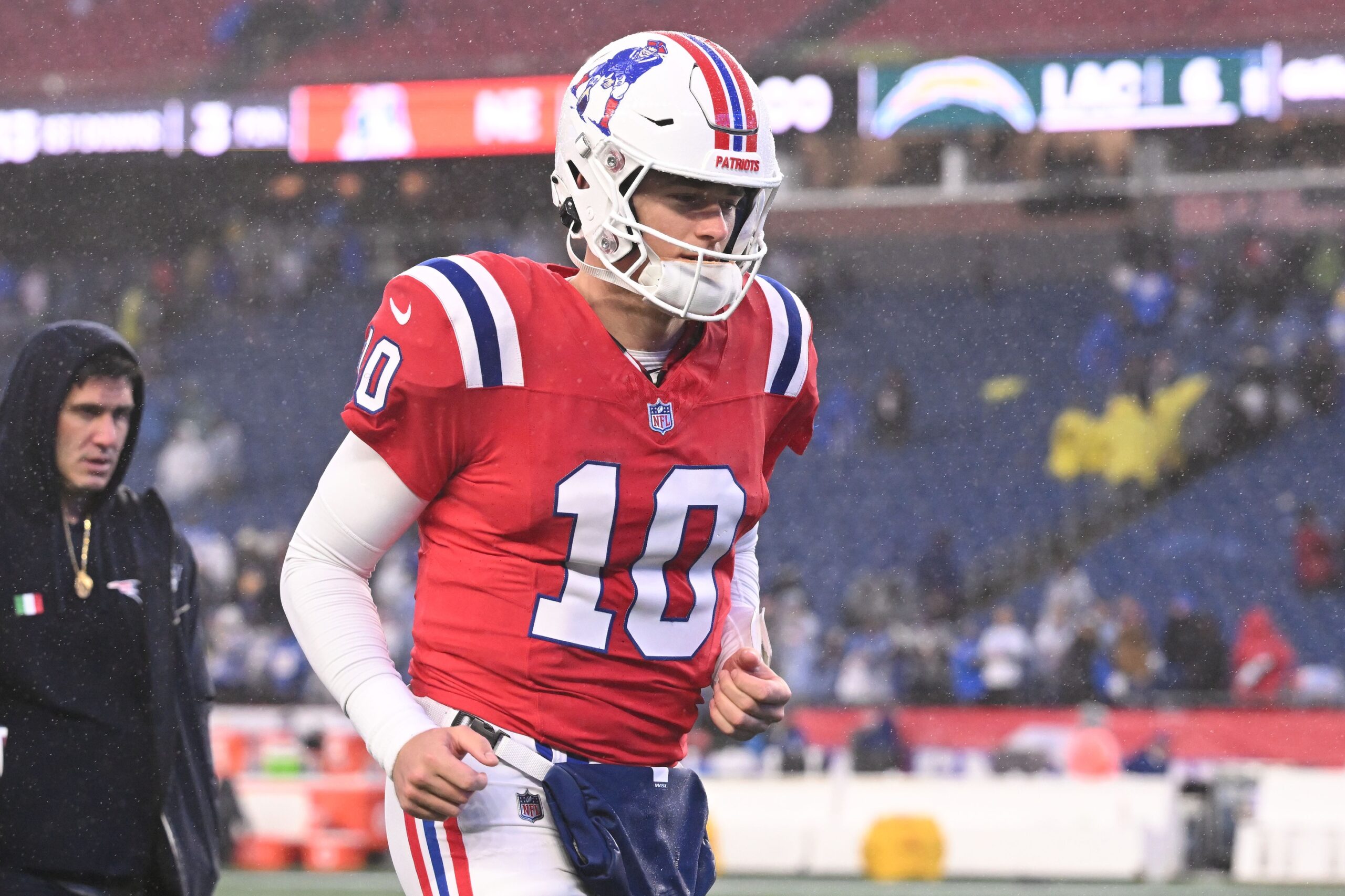 Dec 3, 2023; Foxborough, Massachusetts, USA; New England Patriots quarterback Mac Jones (10) walks off of the field after a game against the Los Angeles Chargers during the second half at Gillette Stadium. Mandatory Credit: Brian Fluharty-USA TODAY Sports