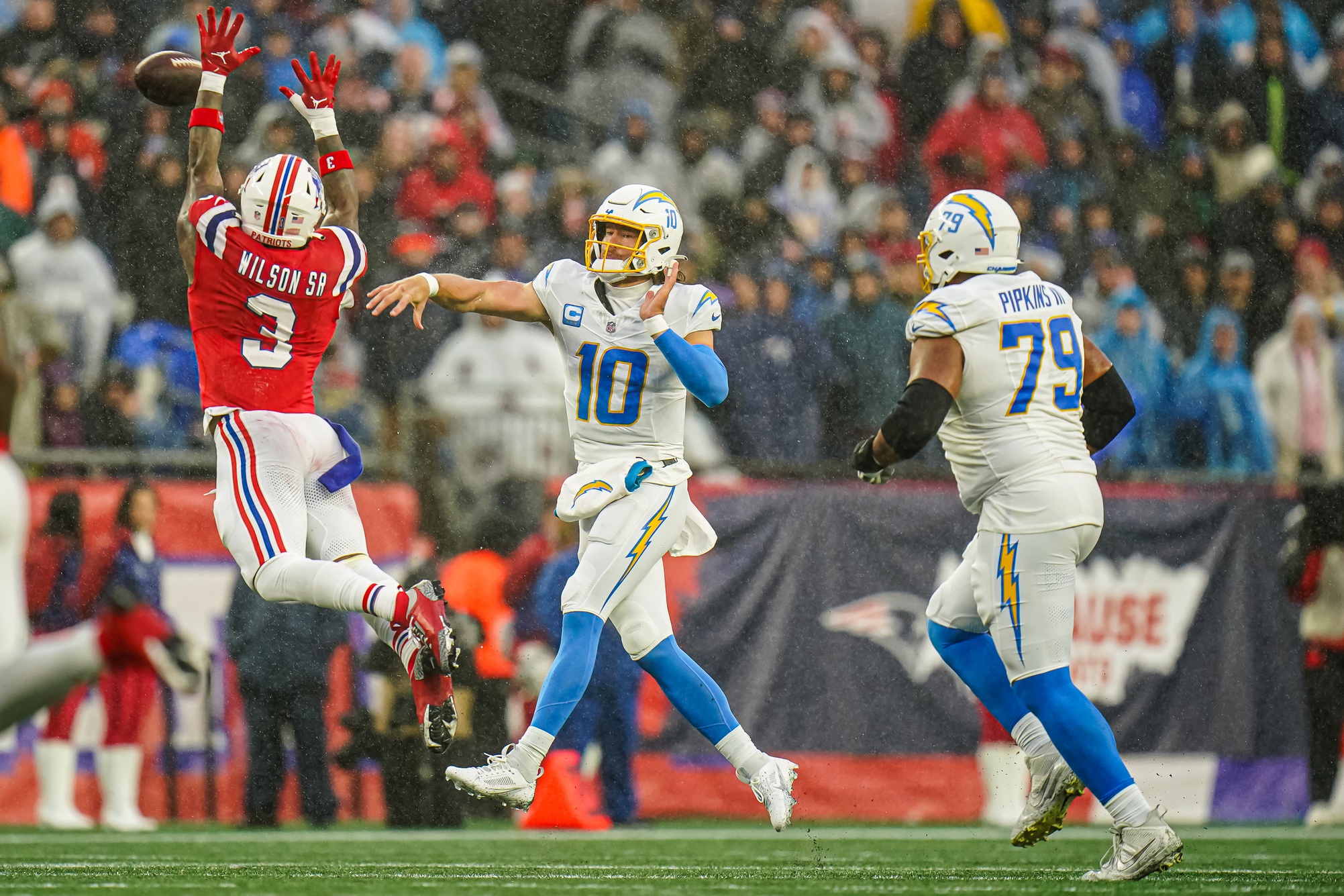 Dec 3, 2023; Foxborough, Massachusetts, USA; Los Angeles Chargers quarterback Justin Herbert (10) throws a pass against New England Patriots linebacker Mack Wilson Sr. (3) in the second half at Gillette Stadium. Mandatory Credit: David Butler II-USA TODAY Sports