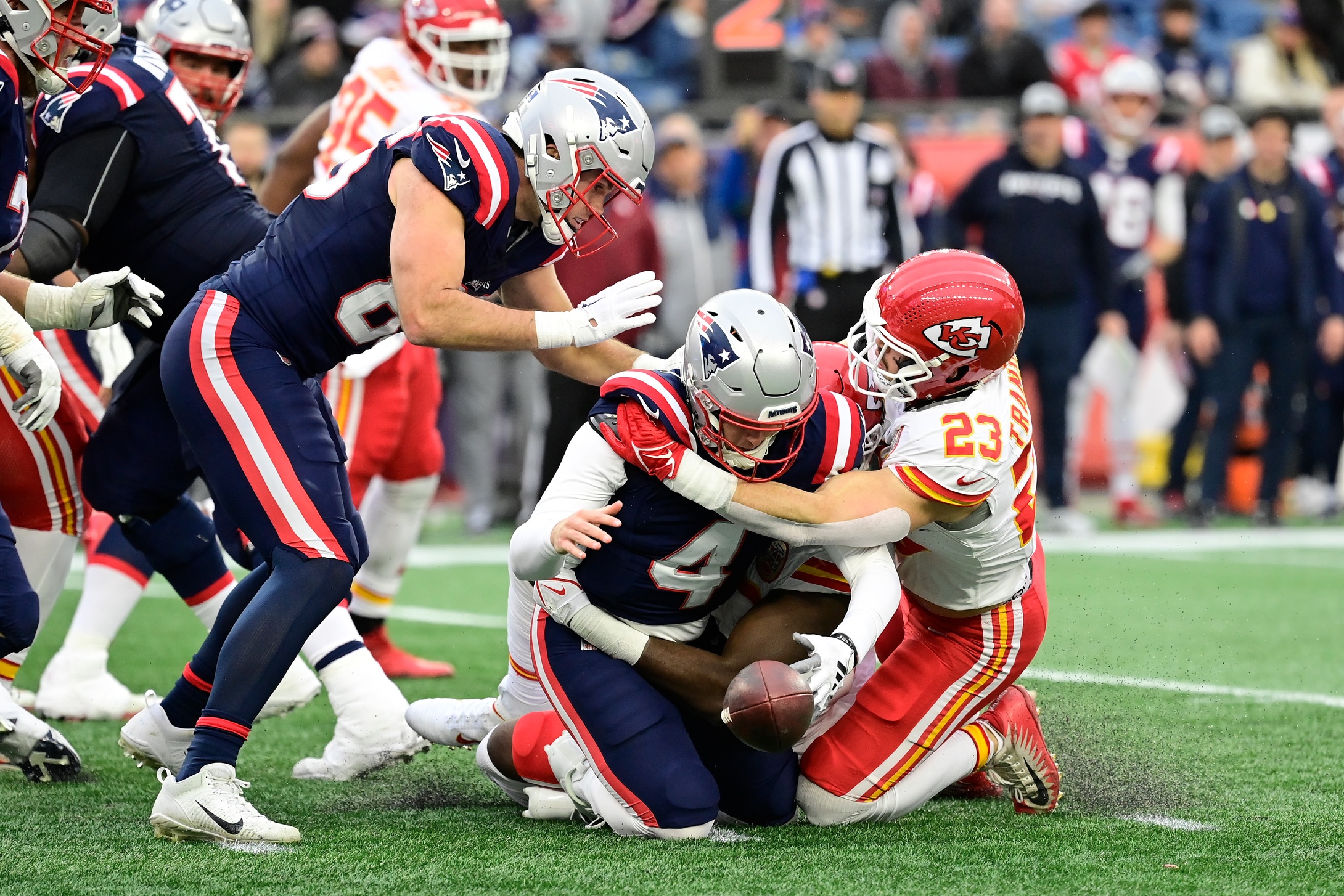 Dec 17, 2023; Foxborough, Massachusetts, USA; New England Patriots quarterback Bailey Zappe (4) fumbles while being sacked by Kansas City Chiefs linebacker Drue Tranquill (23) during the second half at Gillette Stadium. Mandatory Credit: Eric Canha-USA TODAY Sports