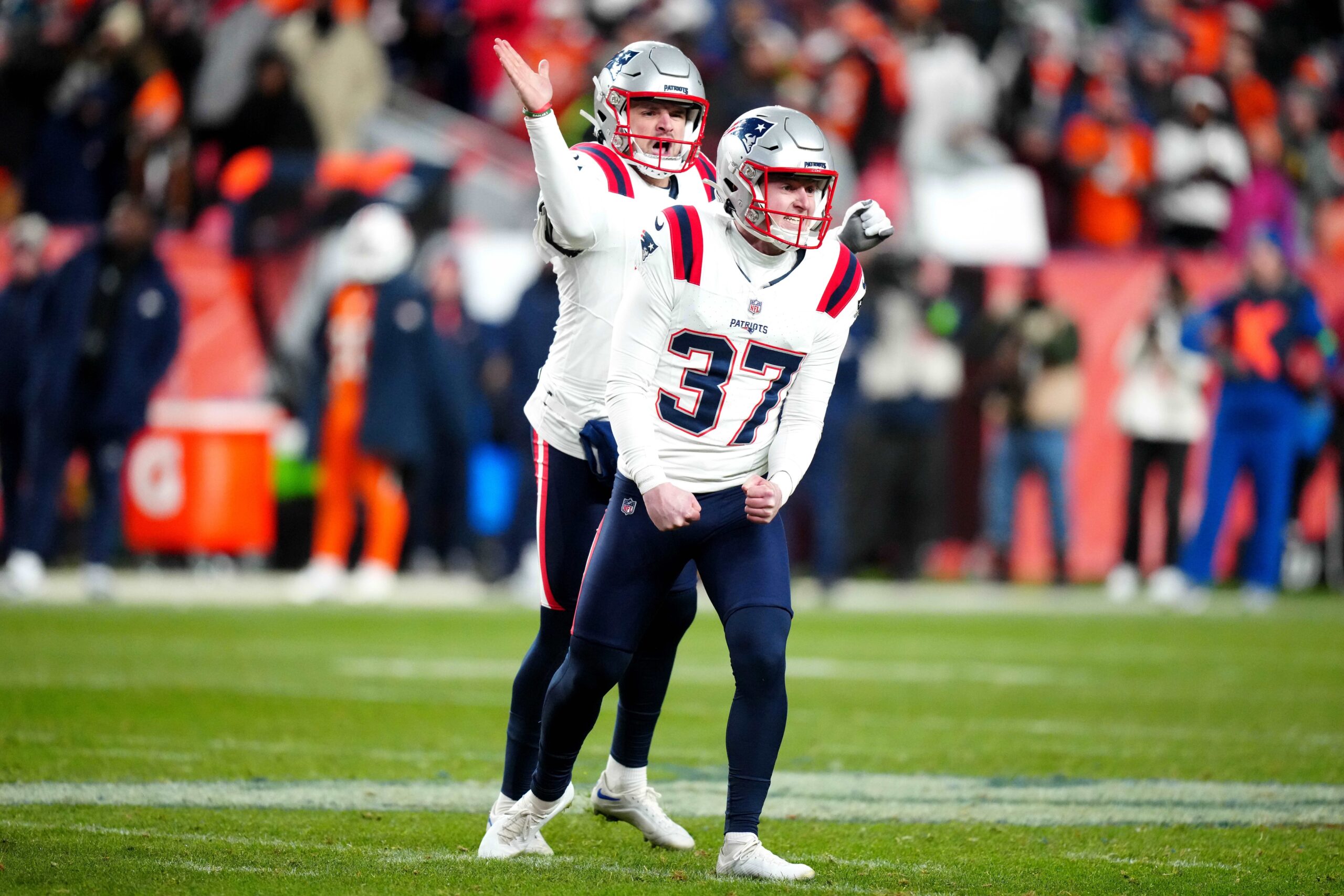 Dec 24, 2023; Denver, Colorado, USA; New England Patriots place kicker Chad Ryland (37) and punter Bryce Baringer (17) celebrate the Denver Broncos at Empower Field at Mile High. Mandatory Credit: Ron Chenoy-USA TODAY Sports