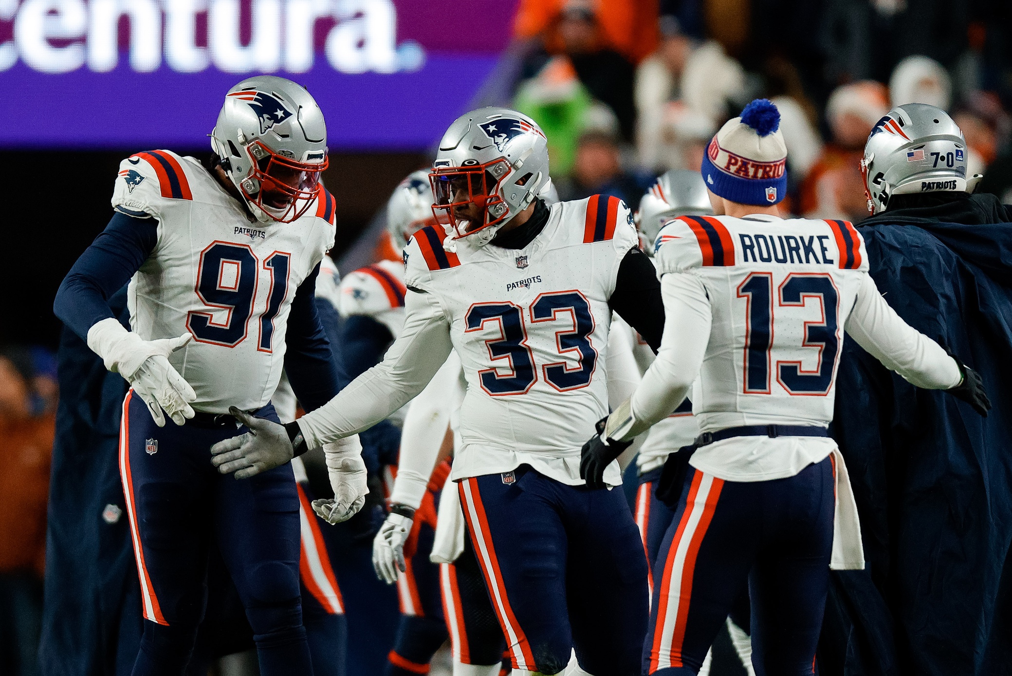 Dec 24, 2023; Denver, Colorado, USA; New England Patriots linebacker Anfernee Jennings (33) and defensive end Deatrich Wise Jr. (91) and quarterback Nathan Rourke (13) react after a play in the first quarter against the Denver Broncos at Empower Field at Mile High. Mandatory Credit: Isaiah J. Downing-USA TODAY Sports