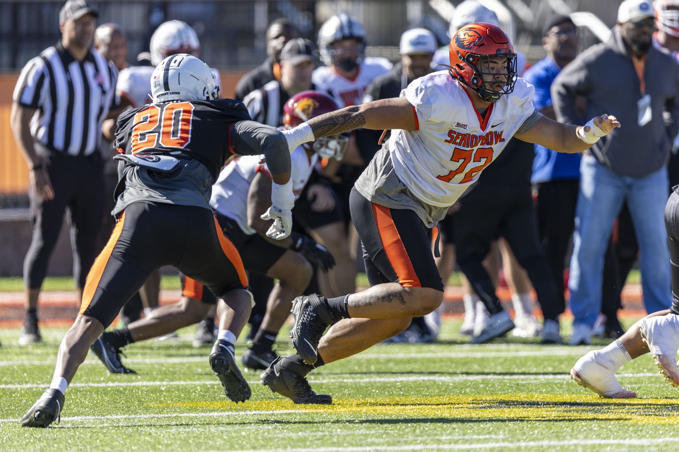 Jan 31, 2024; Mobile, AL, USA; National offensive lineman Taliese Fuaga of Oregon State (72) shifts to an assignment during practice for the National team at Hancock Whitney Stadium. Mandatory Credit: Vasha Hunt-USA TODAY Sports
Note: National edge Adisa Isaac of Penn State (20) Is pictured at left.