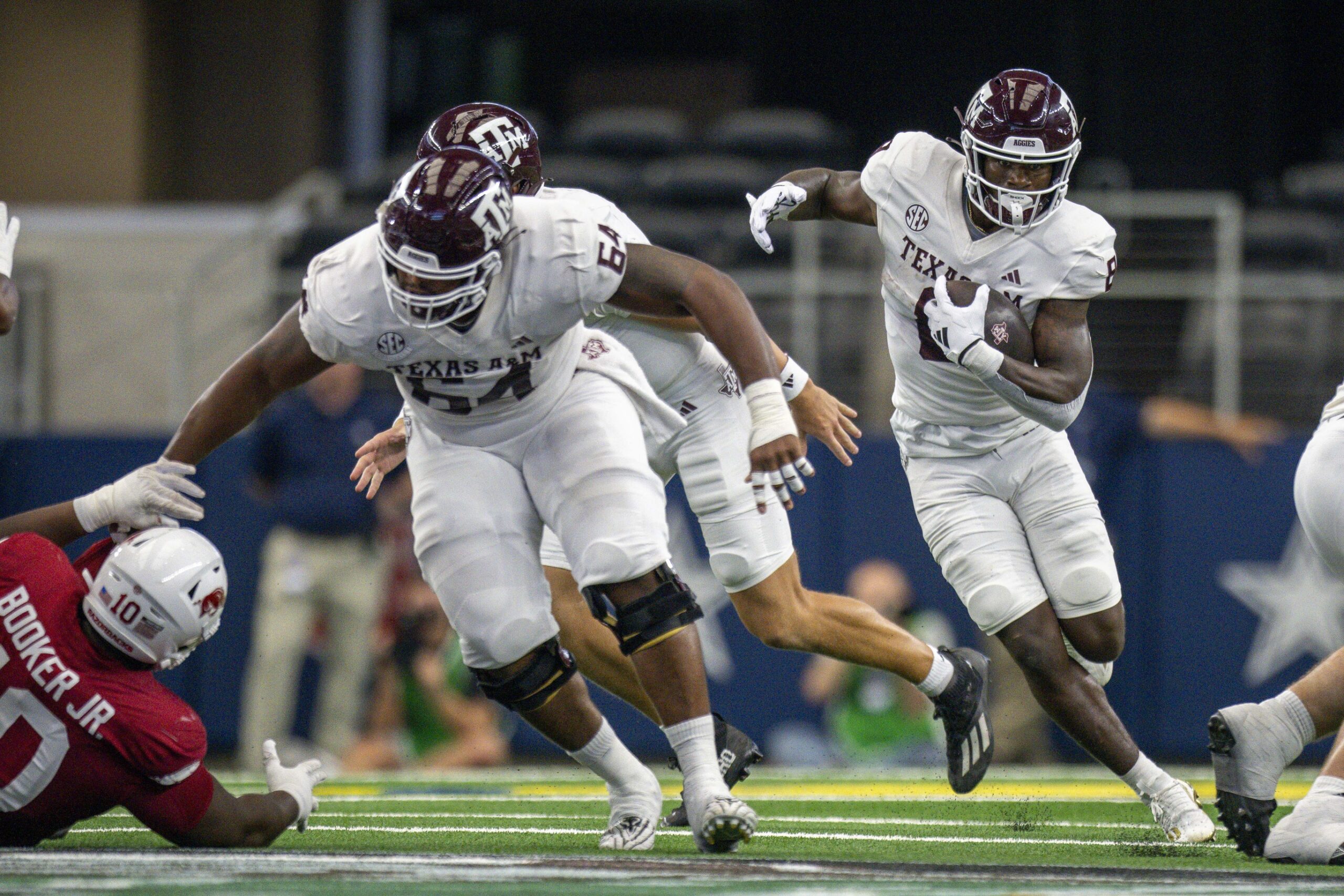 Sep 30, 2023; Arlington, Texas, USA; Texas A&M Aggies offensive lineman Layden Robinson (64) and running back Le'Veon Moss (8) In action during the game between the Texas A&M Aggies and the Arkansas Razorbacks at AT&T Stadium. Mandatory Credit: Jerome Miron-USA TODAY Sports
