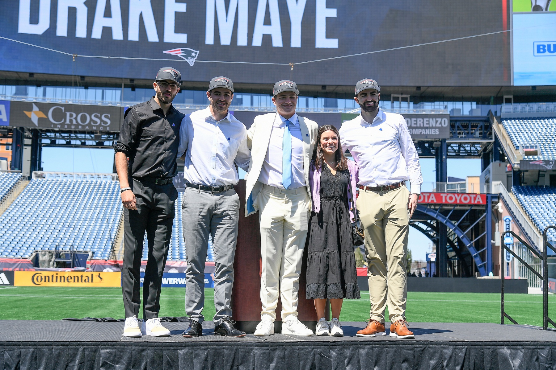 Apr 26, 2024; Foxborough, MA, USA; New England Patriots number one draft pick quarterback Drake Maye (C) introduces (L-R: Beau, Cole, Luke) and his girlfriend since 7th grade (Ann Michael) on the game field at Gillette Stadium. Mandatory Credit: Eric Canha-USA TODAY Sports