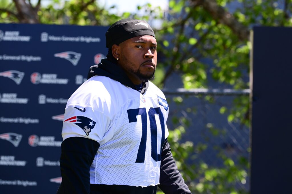Jun 10, 2024; Foxborough, MA, USA; New England Patriots offensive tackle Caedan Wallace (70) walks to the practice fields for minicamp at Gillette Stadium. Mandatory Credit: Eric Canha-USA TODAY Sports