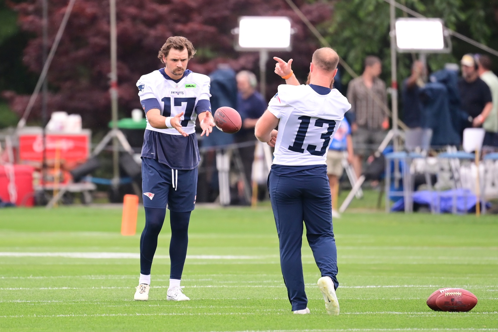 Jul 24, 2024; Foxborough, MA, USA;  New England Patriots punter Bryce Baringer (17)  and place kicker Joey Slye (13) toss a ball at   training camp at Gillette Stadium. Mandatory Credit: Eric Canha-USA TODAY Sports