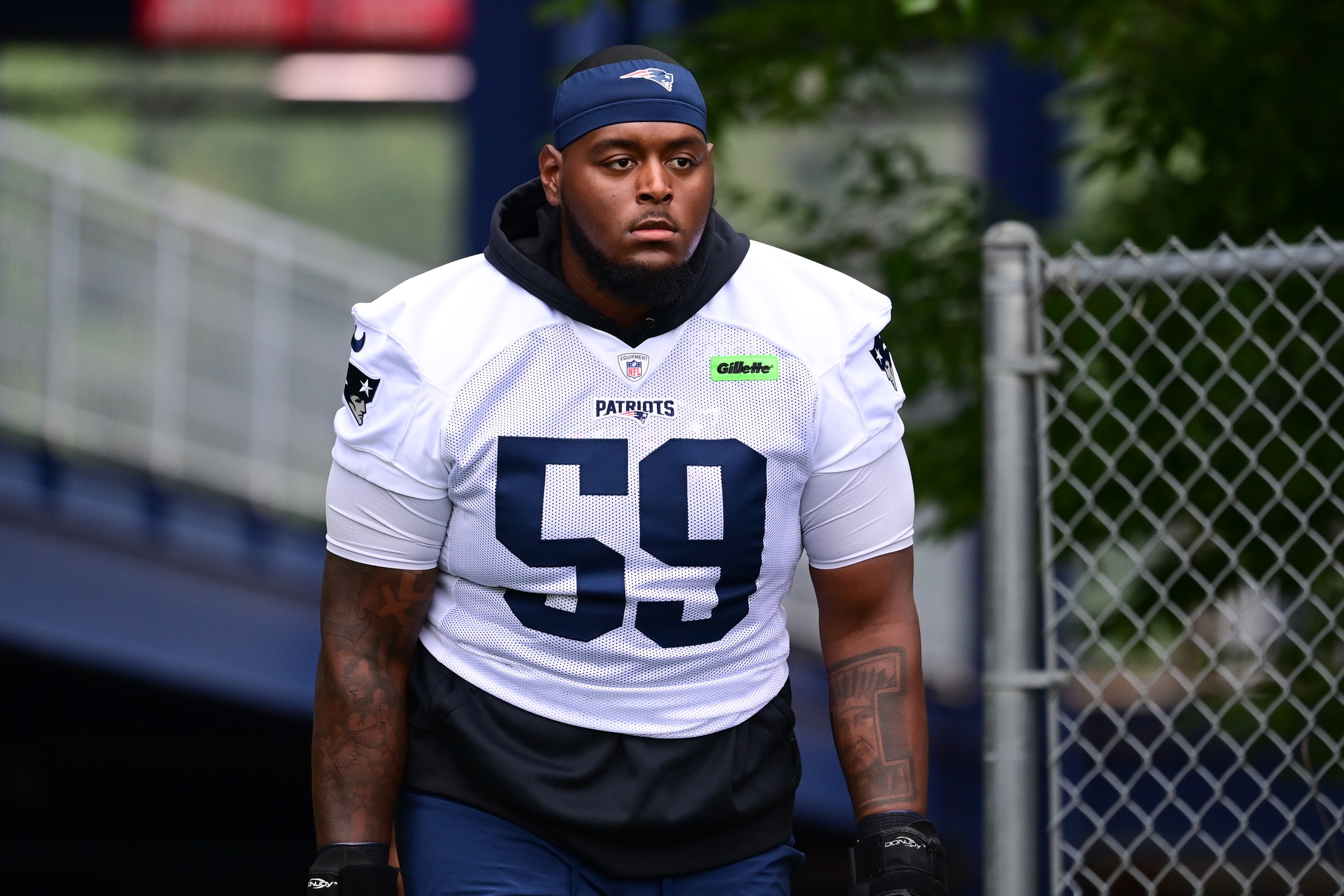Jul 24, 2024; Foxborough, MA, USA; New England Patriots offensive tackle Vederian Lowe (59) walks to the practice field during training camp at Gillette Stadium. Mandatory Credit: Eric Canha-USA TODAY Sports