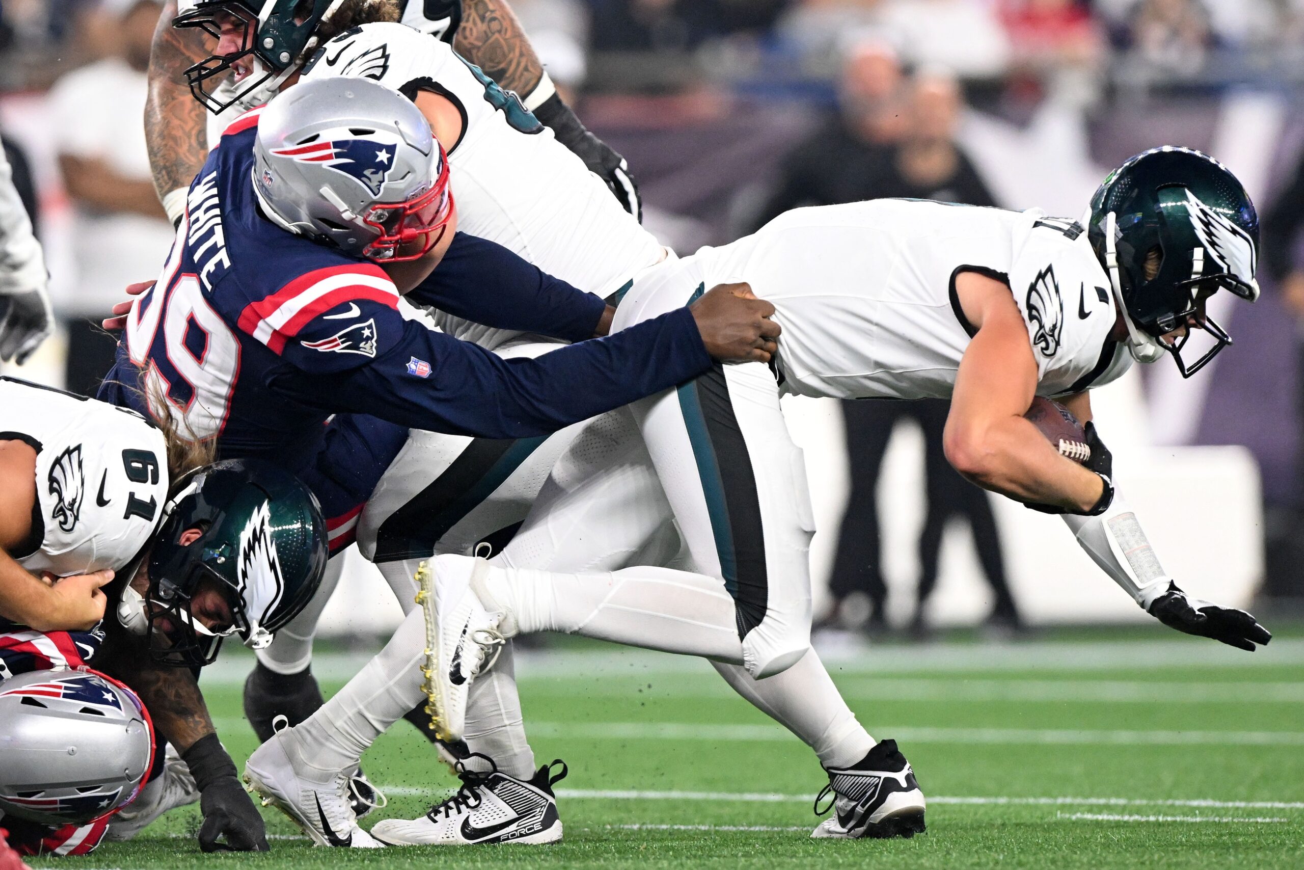 Aug 15, 2024; Foxborough, Massachusetts, USA; New England Patriots defensive end Keion White (99) tackles Philadelphia Eagles quarterback Kenny Pickett (7) during the first half at Gillette Stadium. Mandatory Credit: Brian Fluharty-USA TODAY Sports