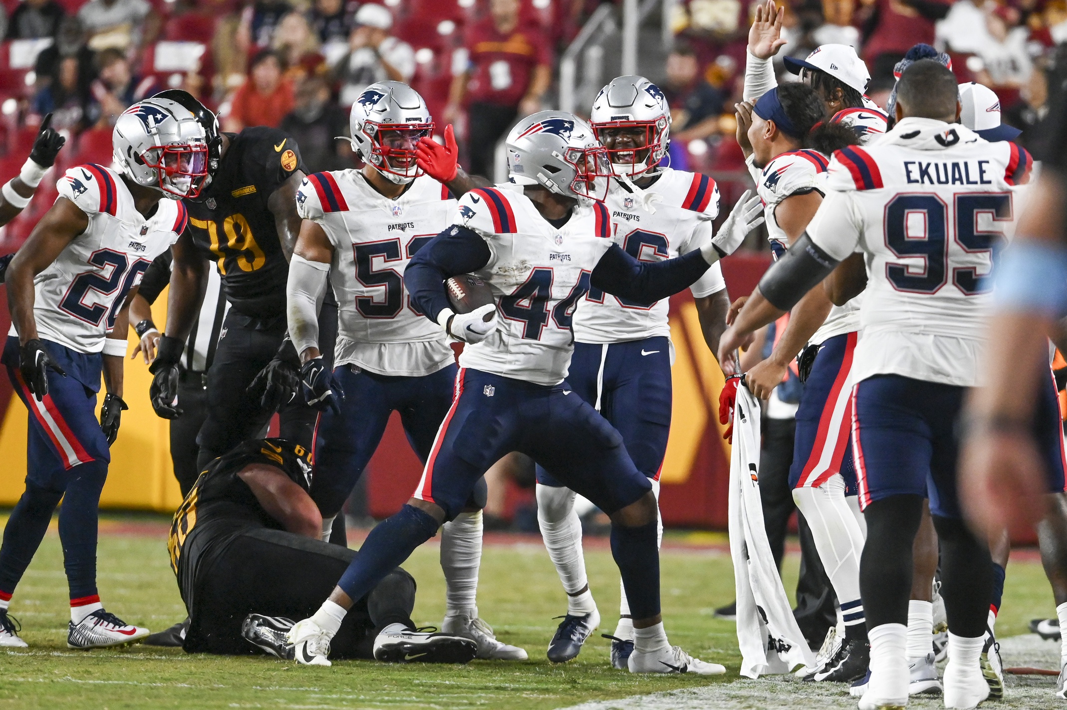 Aug 25, 2024; Landover, Maryland, USA;  New England Patriots linebacker Joe Giles-Harris (44) celebrates with teammates after intercepting a pass during the first half against the Washington Commanders at Commanders Field. Mandatory Credit: Tommy Gilligan-USA TODAY Sports