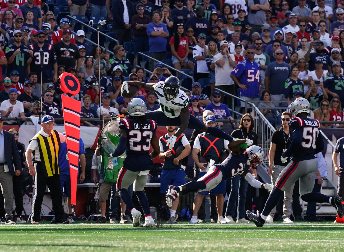 Sep 15, 2024; Foxborough, Massachusetts, USA; Seattle Seahawks wide receiver DK Metcalf (14) makes the play over New England Patriots cornerback Jonathan Jones (31) in the second half at Gillette Stadium. Mandatory Credit: David Butler II-Imagn Images