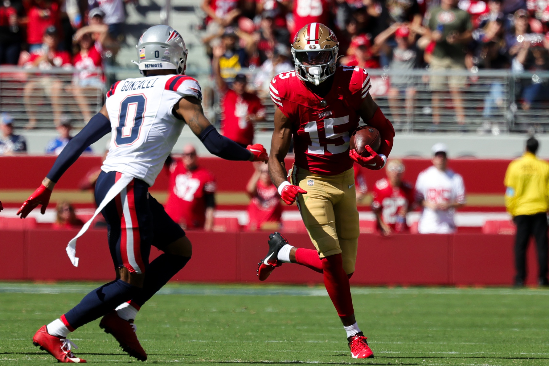 Sep 29, 2024; Santa Clara, California, USA; San Francisco 49ers wide receiver Jauan Jennings (15) runs the ball against New England Patriots cornerback Christian Gonzalez (0) during the second quarter at Levi's Stadium. Mandatory Credit: Sergio Estrada-Imagn Images