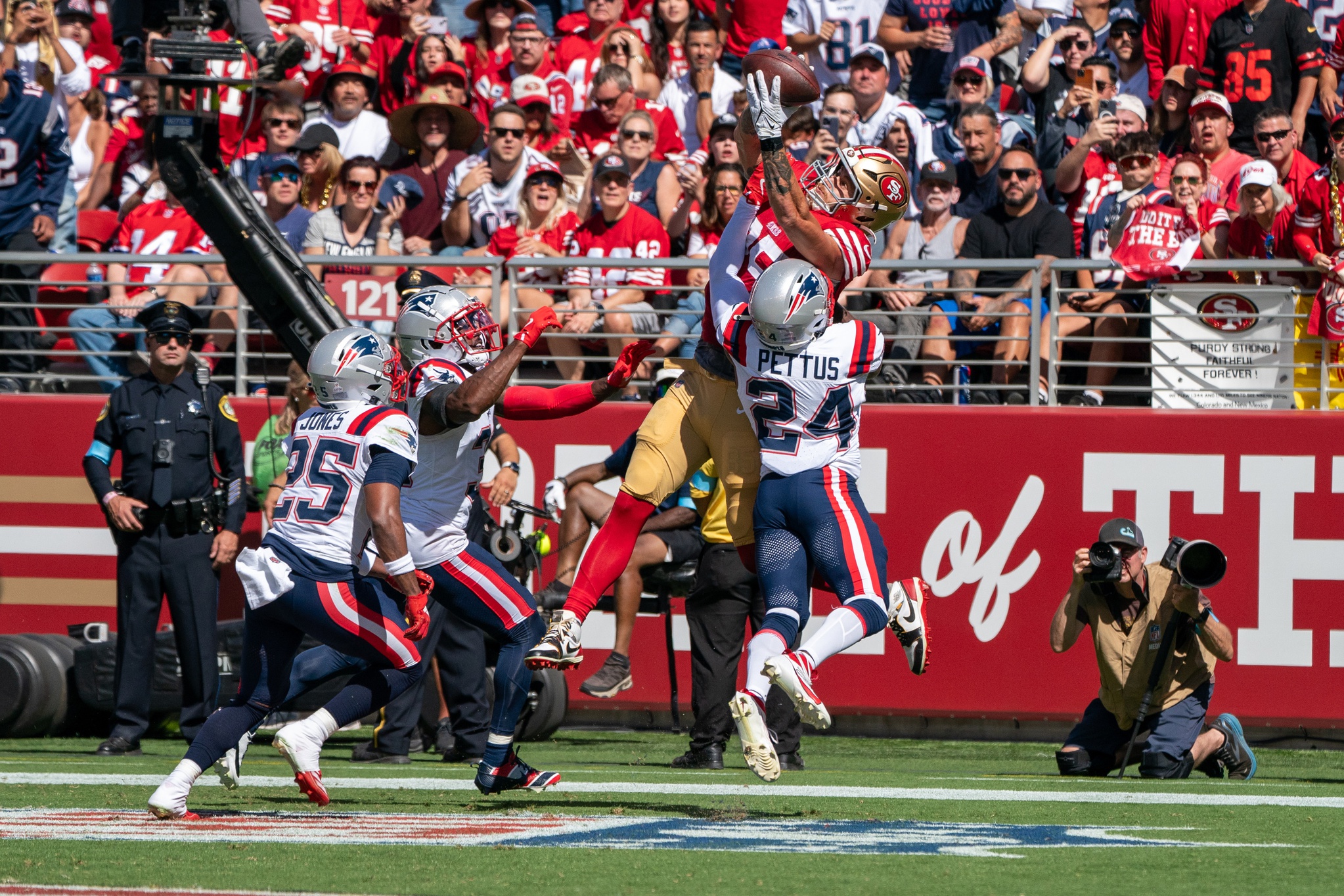 Sep 29, 2024; Santa Clara, California, USA; San Francisco 49ers tight end George Kittle (85) catches the football for a touchdown against New England Patriots safety Dell Pettus (24) during the second quarter at Levi's Stadium. Mandatory Credit: Neville E. Guard-Imagn Images