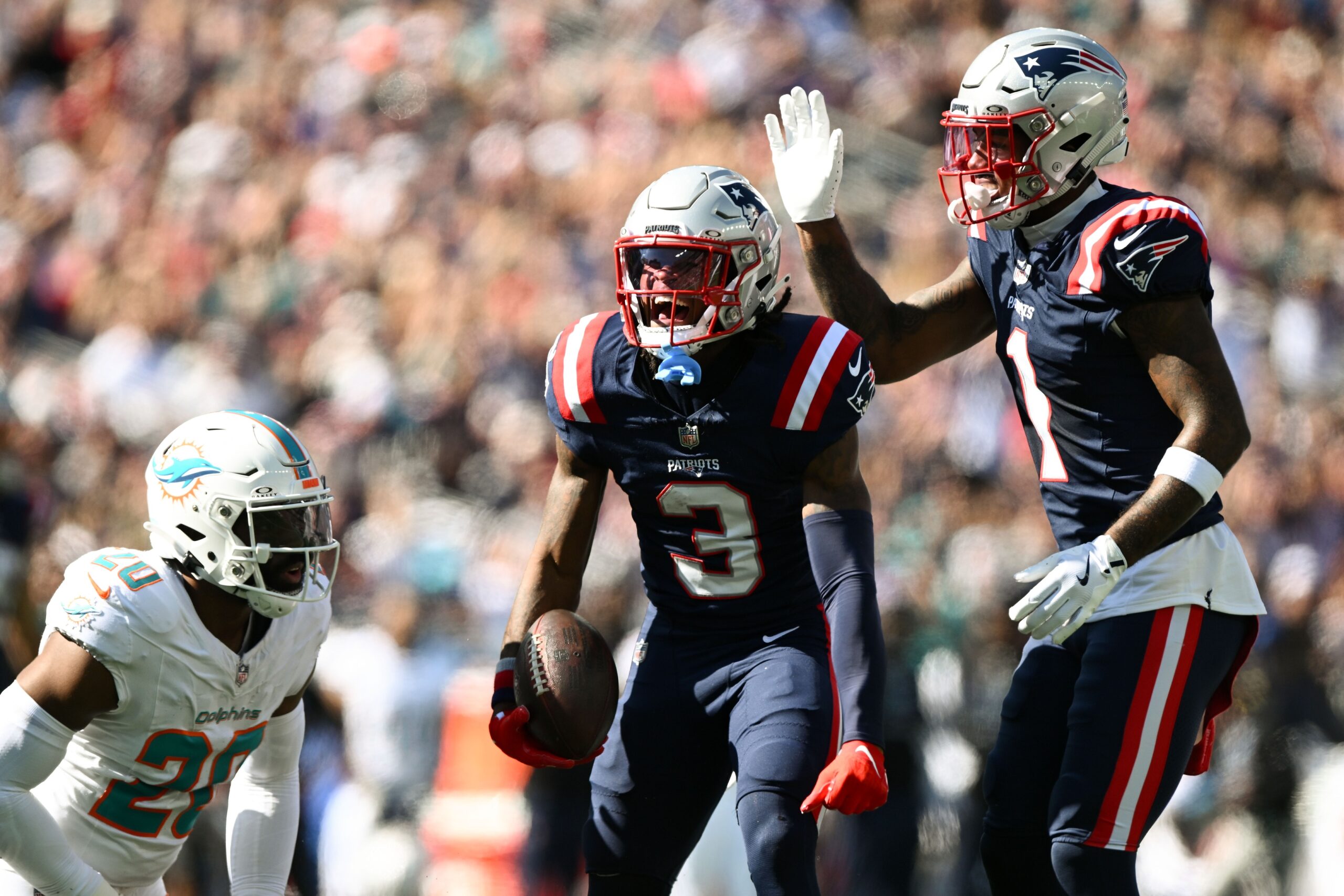 Oct 6, 2024; Foxborough, Massachusetts, USA; New England Patriots wide receiver DeMario Douglas (3) reacts after making a completion against the Miami Dolphins during the first half at Gillette Stadium. Mandatory Credit: Brian Fluharty-Imagn Images