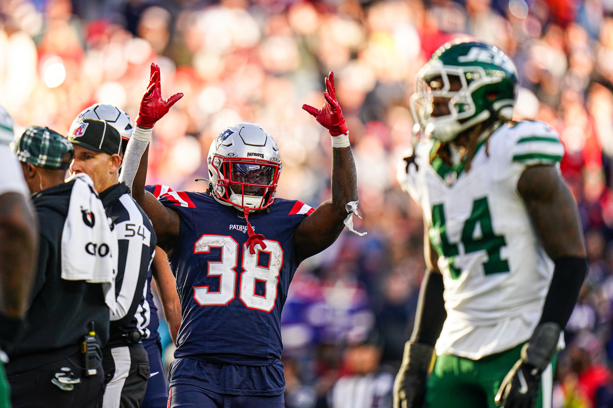 Oct 27, 2024; Foxborough, Massachusetts, USA; New England Patriots running back Rhamondre Stevenson (38) reacts after his touchdown is confirmed against the New York Jets in the second half at Gillette Stadium. Mandatory Credit: David Butler II-Imagn Images